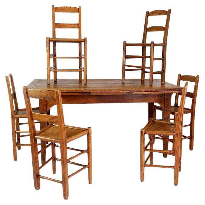 Dining room set of one extendable wooden table and set of 6 chairs For Sale
