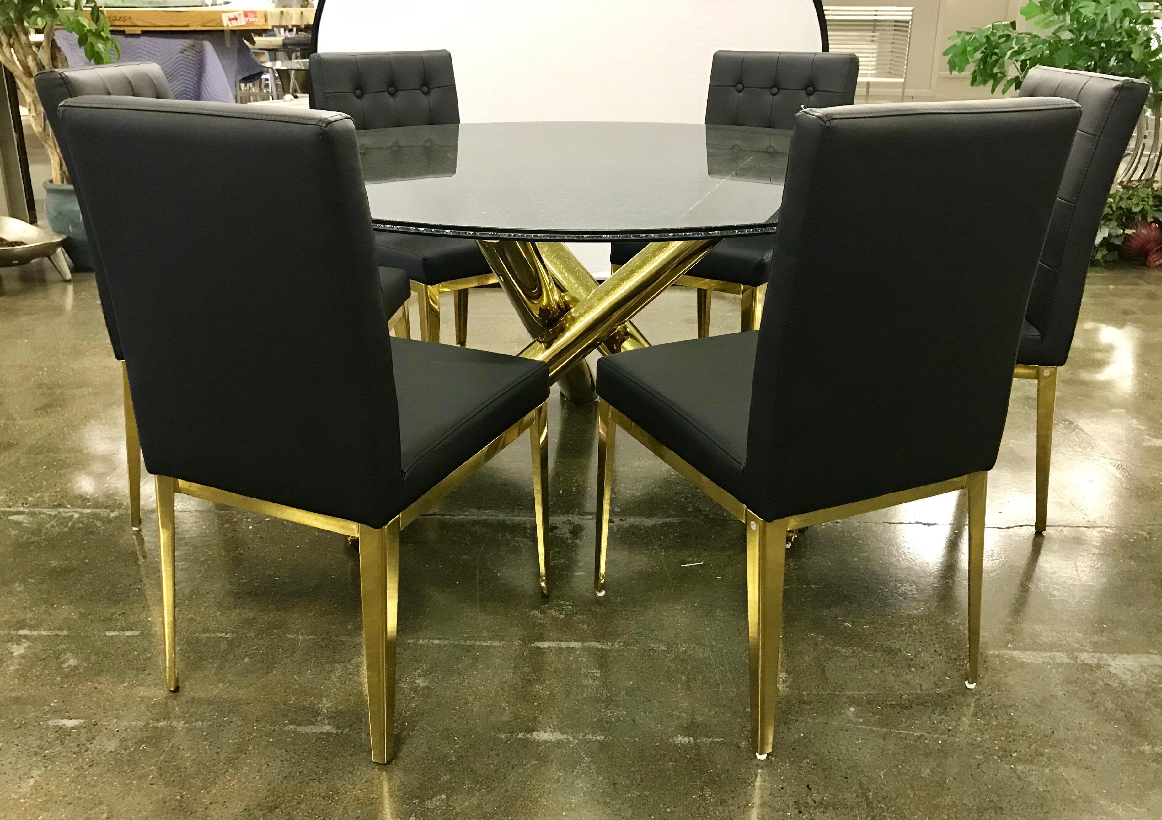 Stunning round crackled glass top table on a brass sculptural base with six matching black leather
chairs with brass legs. Chairs have button tufting on the back. The set is in excellent condition and looks new. The glass top has the crackling