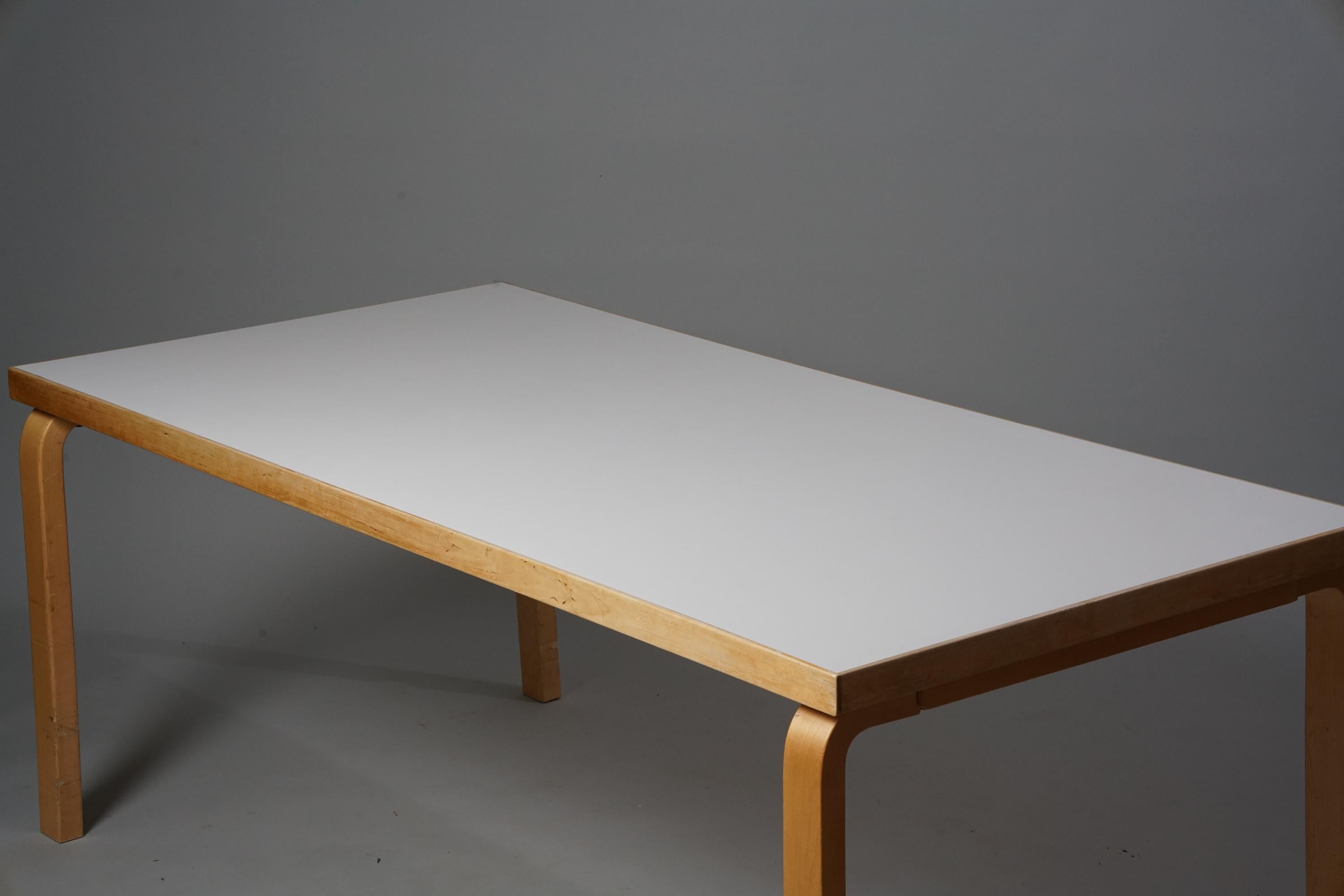 Dining room table, designed by Alvar Aalto, manufactured by Oy Huonekalu- ja Rakennustyötehdas Ab, 1950s. Birch with linoleum table top. Good vintage condition, patina on the legs consistent with age and use. 

Alvar Aalto (1898-1976) is probably