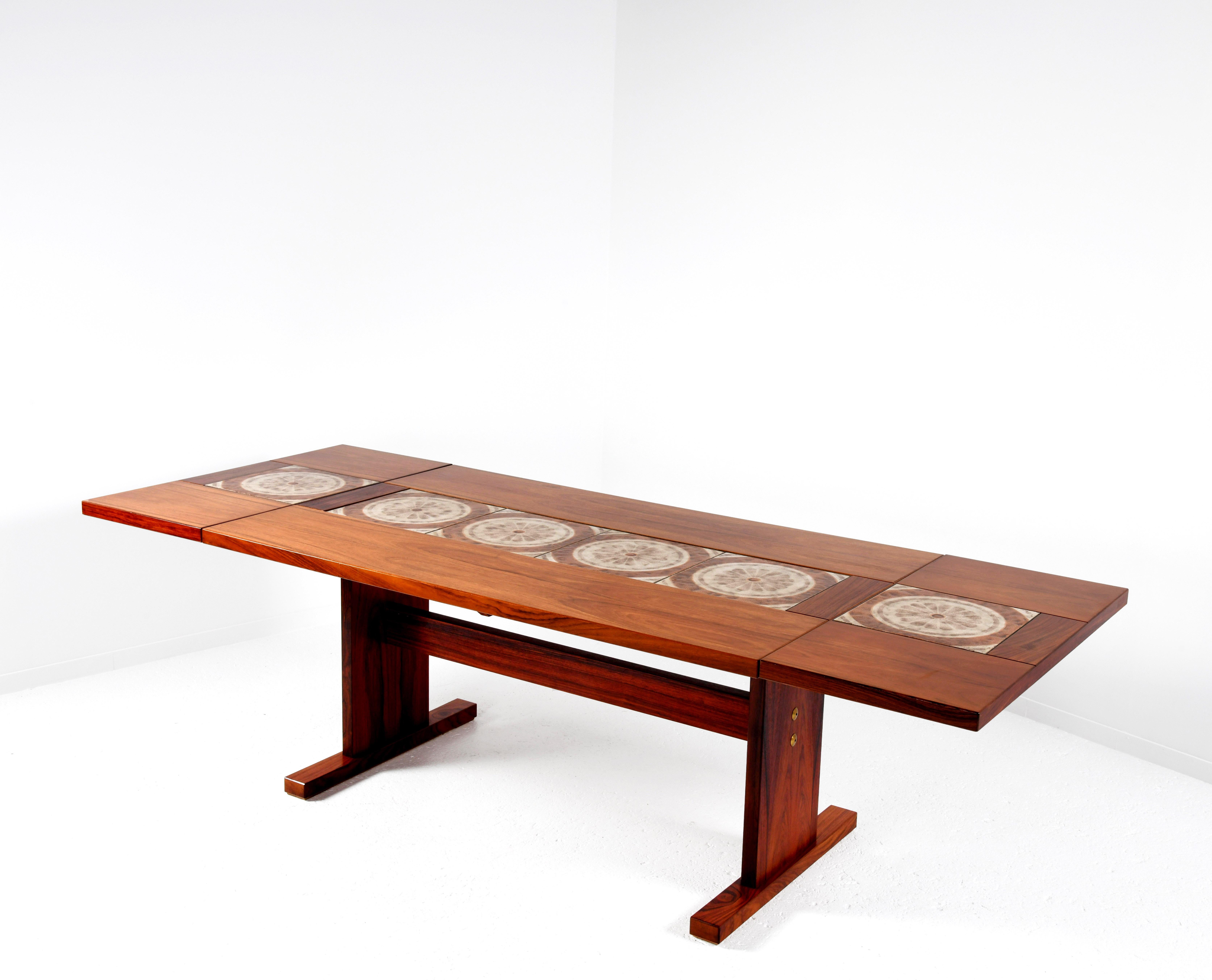 Dining table produced by Gangso Møbler in Denmark in the 1960s, designed with floral ceramics by Poul Hermann Poulsen. The rosewood table has a central section and two extensions that can be raised, folded down or removed completely (see video).
