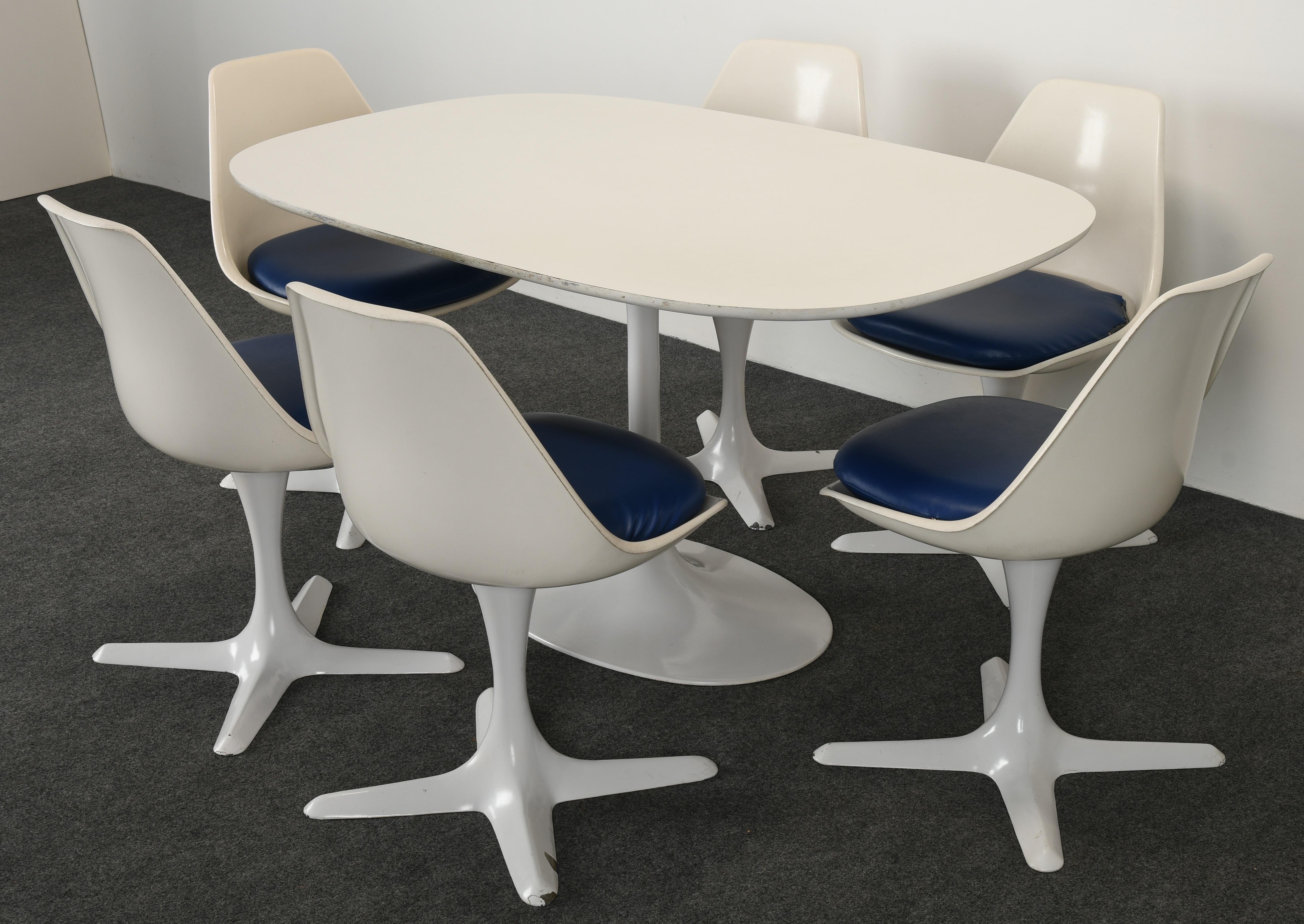 A Modernist Tulip-style table and set of six chairs by Burke International designed by Maurice Burke. This set was modeled after the Eero Saarinen tulip series. The set consists of a dining table and four molded fiberglass swiveling dining chairs.