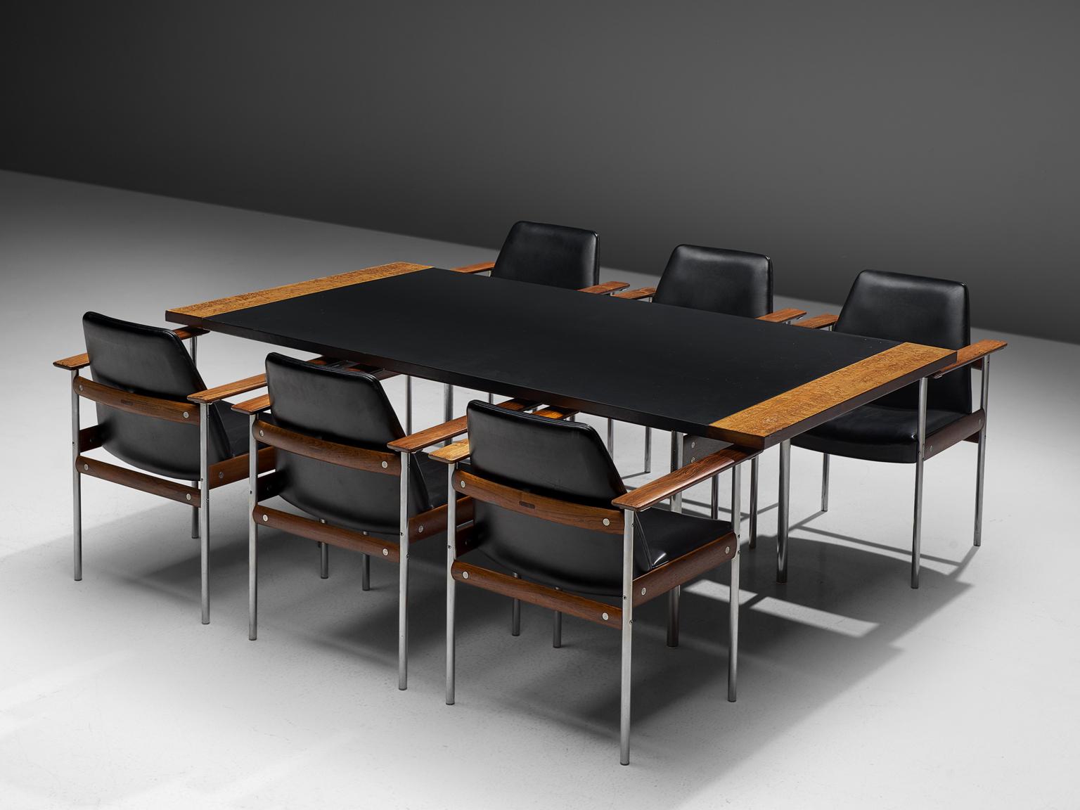 Sven Ivar Dysthe for Dokka, table and chairs, leather, rosewood and steel, Norway, 1960s.

This well crafted executive dining set in rosewood is designed by Sven Ivar Dysthe. 
The base of the conference table and office chairs are made out of