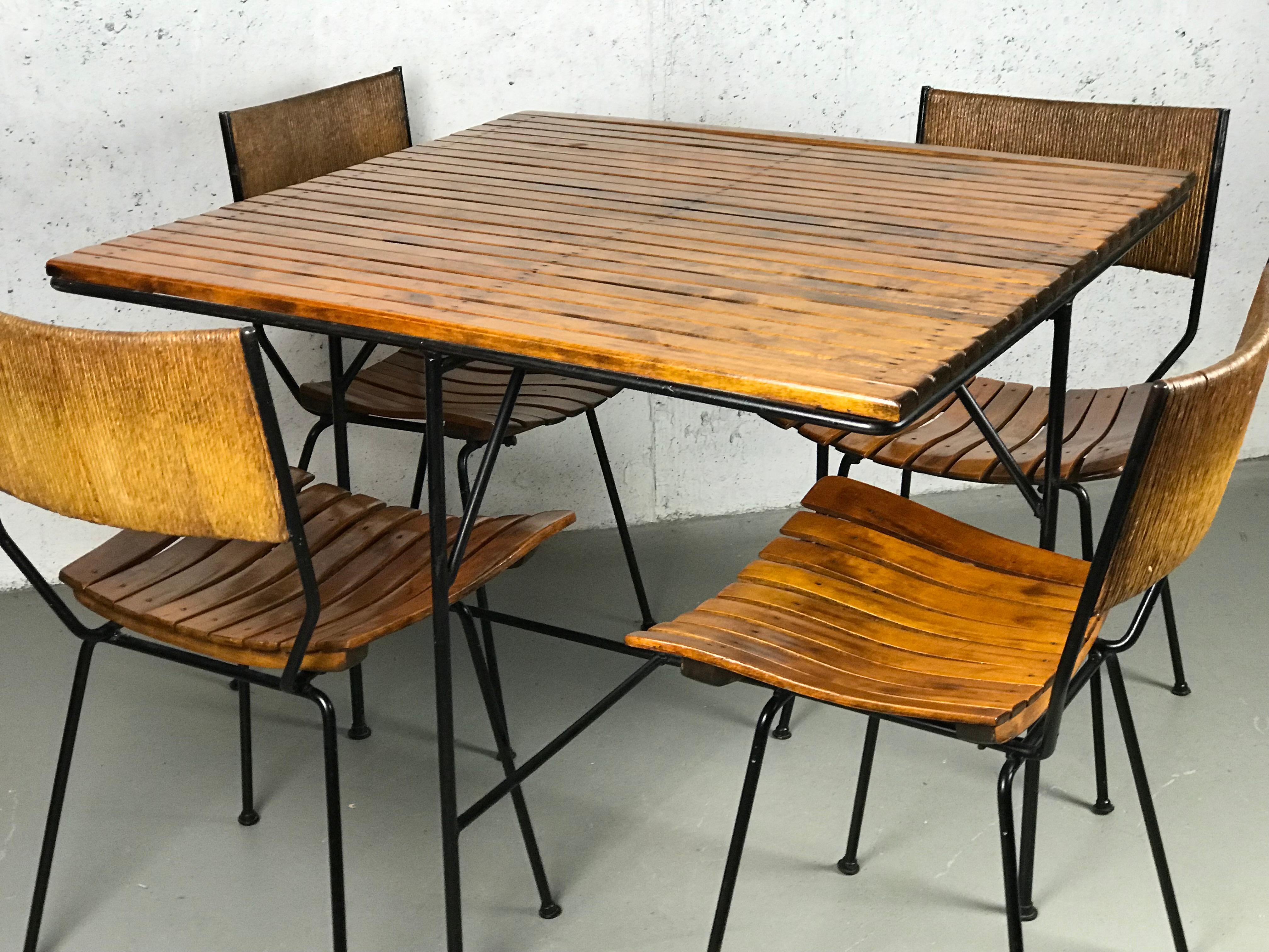Beautiful Minimalist 1950s dining set designed by Arthur Umanoff in iron, rope and wood. 
Shaver Howard manufactured the set for Raymor. The original feet glides are present.
(2) chairs 
Each chair measures: 31