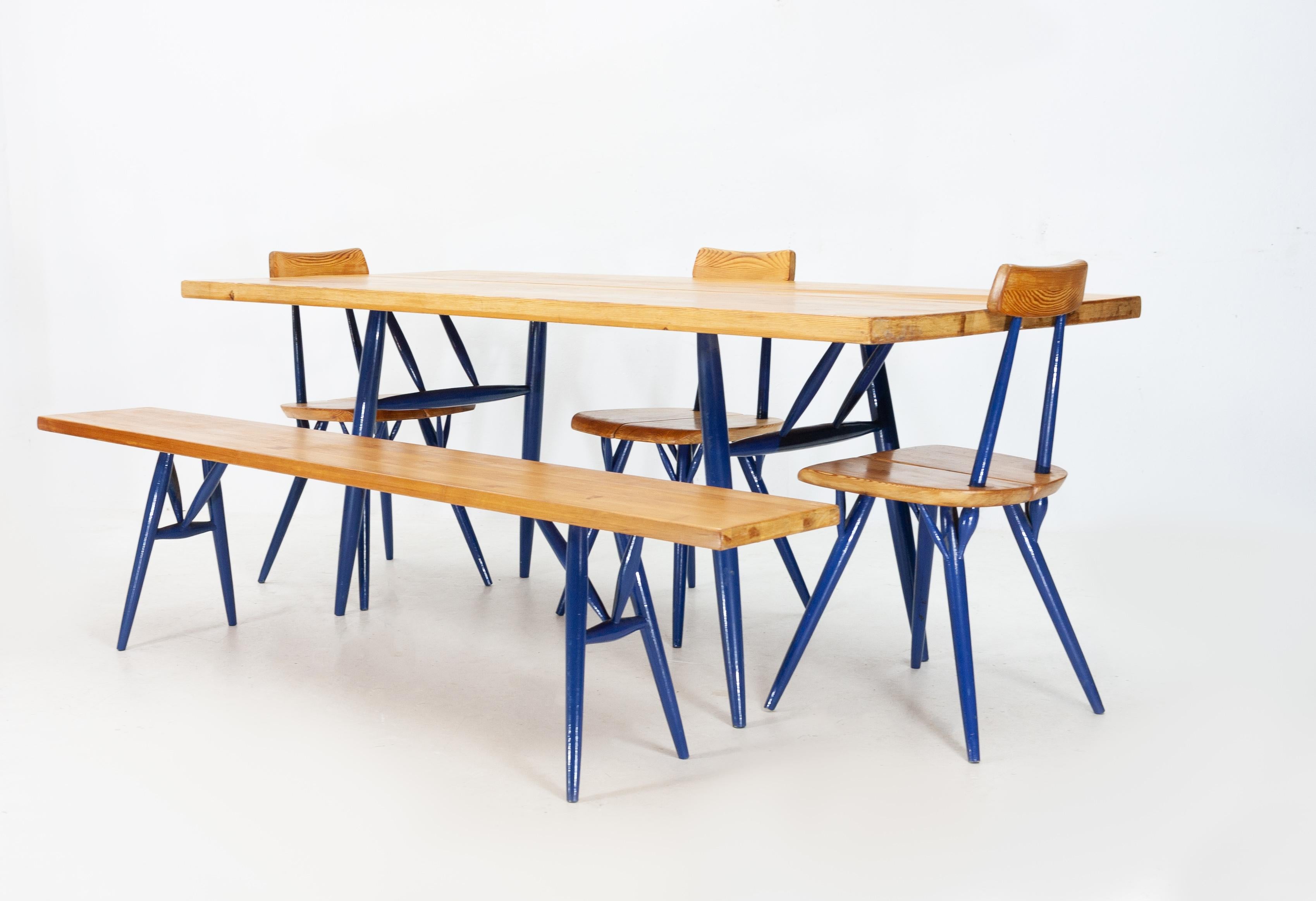 Pirkka dining set. Designed by Iimari Tapiovaara for Laukaan Puu Finland in the 1950s.
Solid pine wood surfaces. The legs have been painted dark blue rather than their original black finish, I like the color so I kept them this way but of course