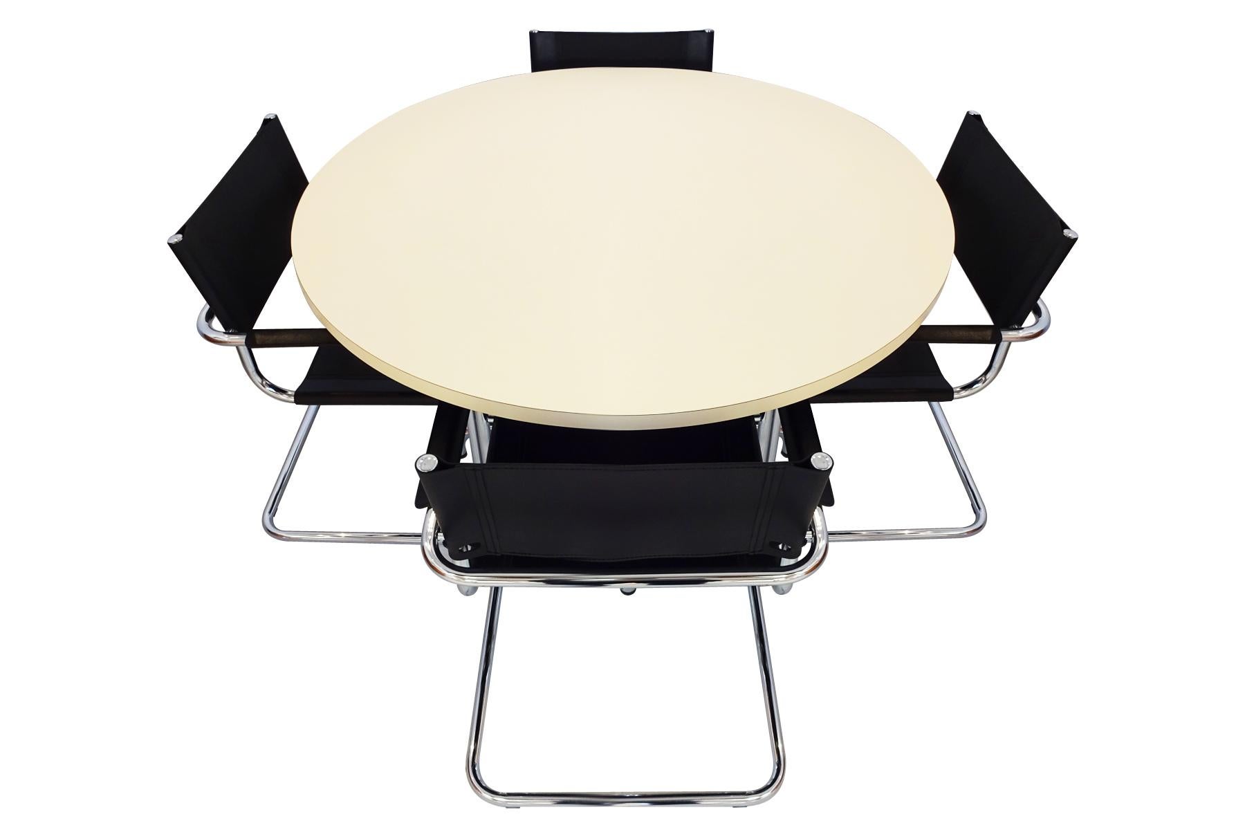 Bauhaus dining set featuring 4 Mart Stam cantilever chairs in black leather and chrome and an original Thonet cream melamine topped and chrome table – circa 1960s.

This is an excellent modernist dining set that has a sophisticated appeal created by