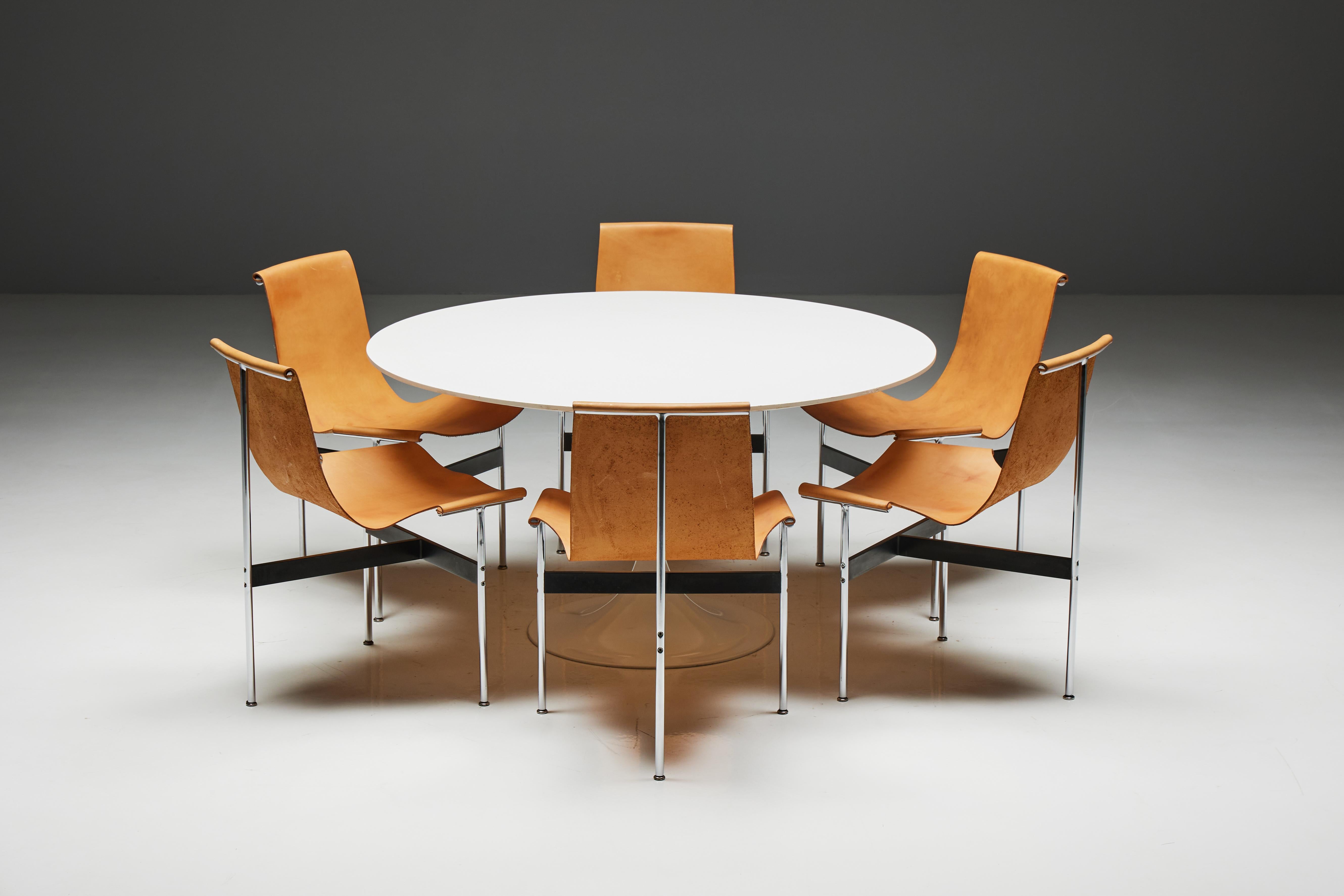 The ultimate mid-century modern ensemble: the T-chairs by Katavolos, Kelley, and Littell, accompanied by a round dining table by Eero Saarinen. Crafted in 1952, the T-chairs boast chrome-plated steel frames, cognac camel leather seats, and an iconic