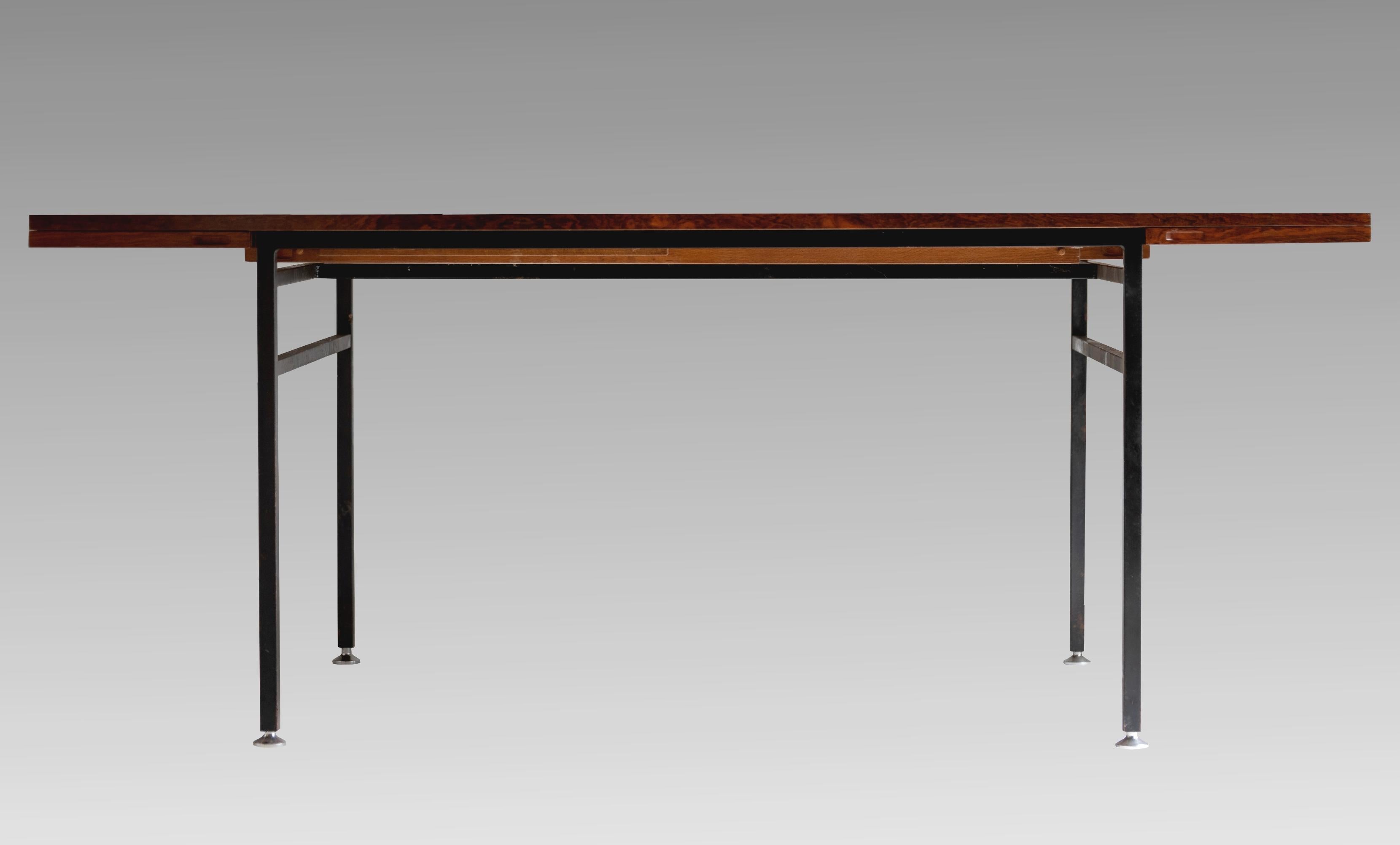 Alain Richard, (1926-2017)
Dining table in rosewood with double extension, series 800, edited by Meubles TV (J.Tricoire & R.Vecchione), France, 1958.
Base in black lacquered metal, adjustable chromed legs.
Labelled under the tray.
In very good