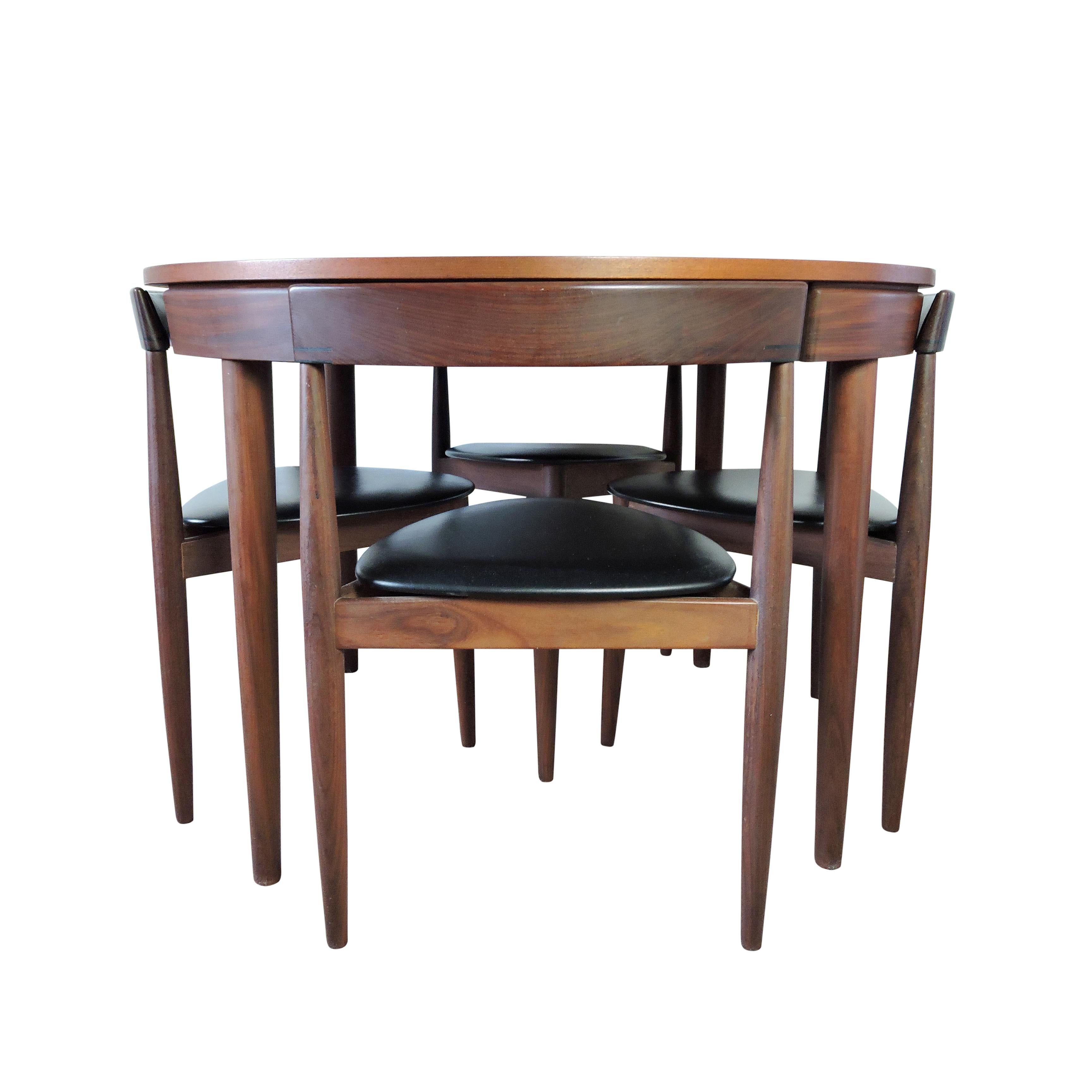 A 1960s teak and Aformosia dining table with four chairs. Manufactured by Frem Rojle in Denmark and designed by Hans Olsen.
The table extends to 156.5cm.