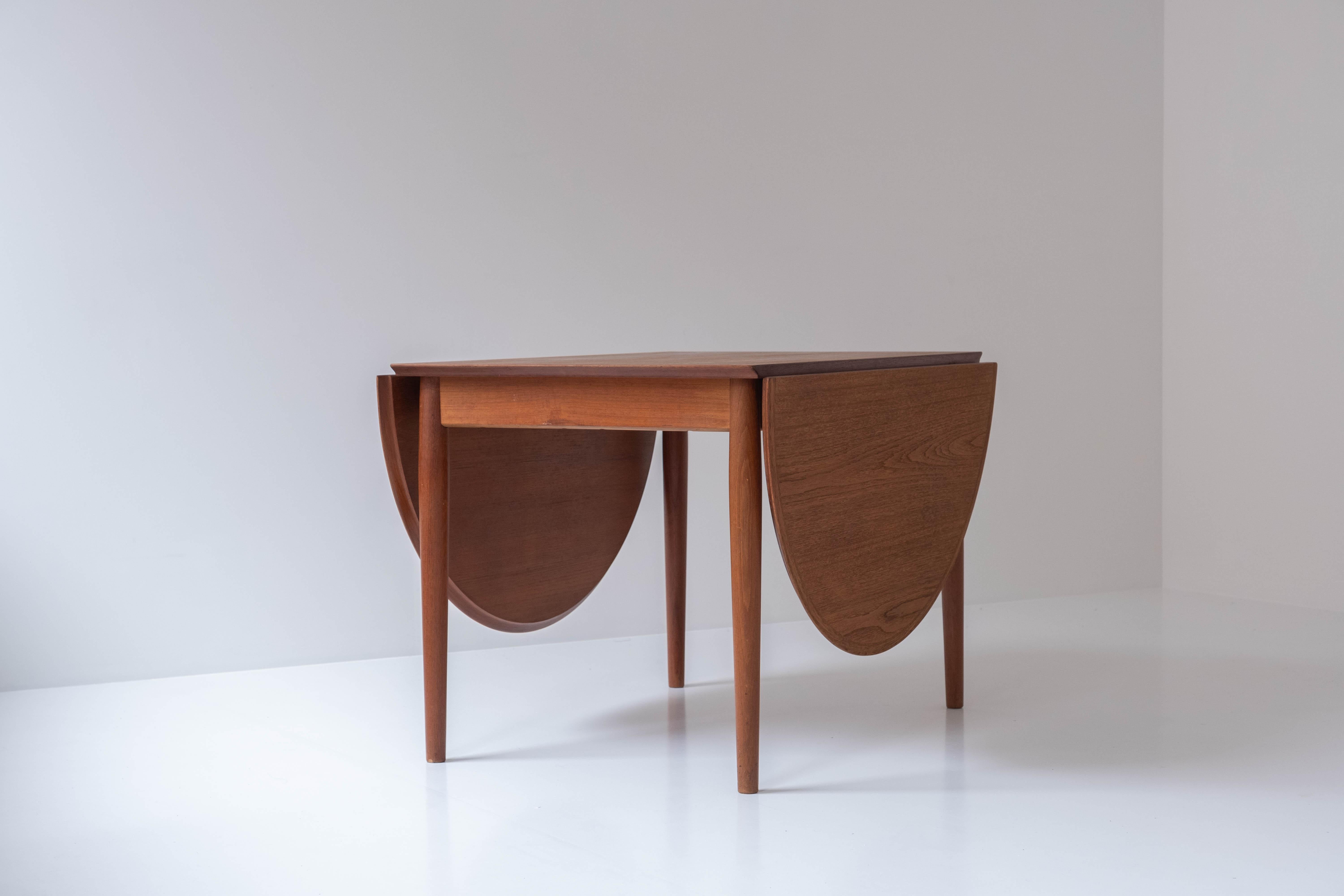 Dining table by Arne Vodder for Sibast Møbler, Denmark, 1960s. This table is a rare version of the Classic 227 dining table, it has only extensions at the ends, not in the middle. This version features a veneered teak top and solid teak legs.