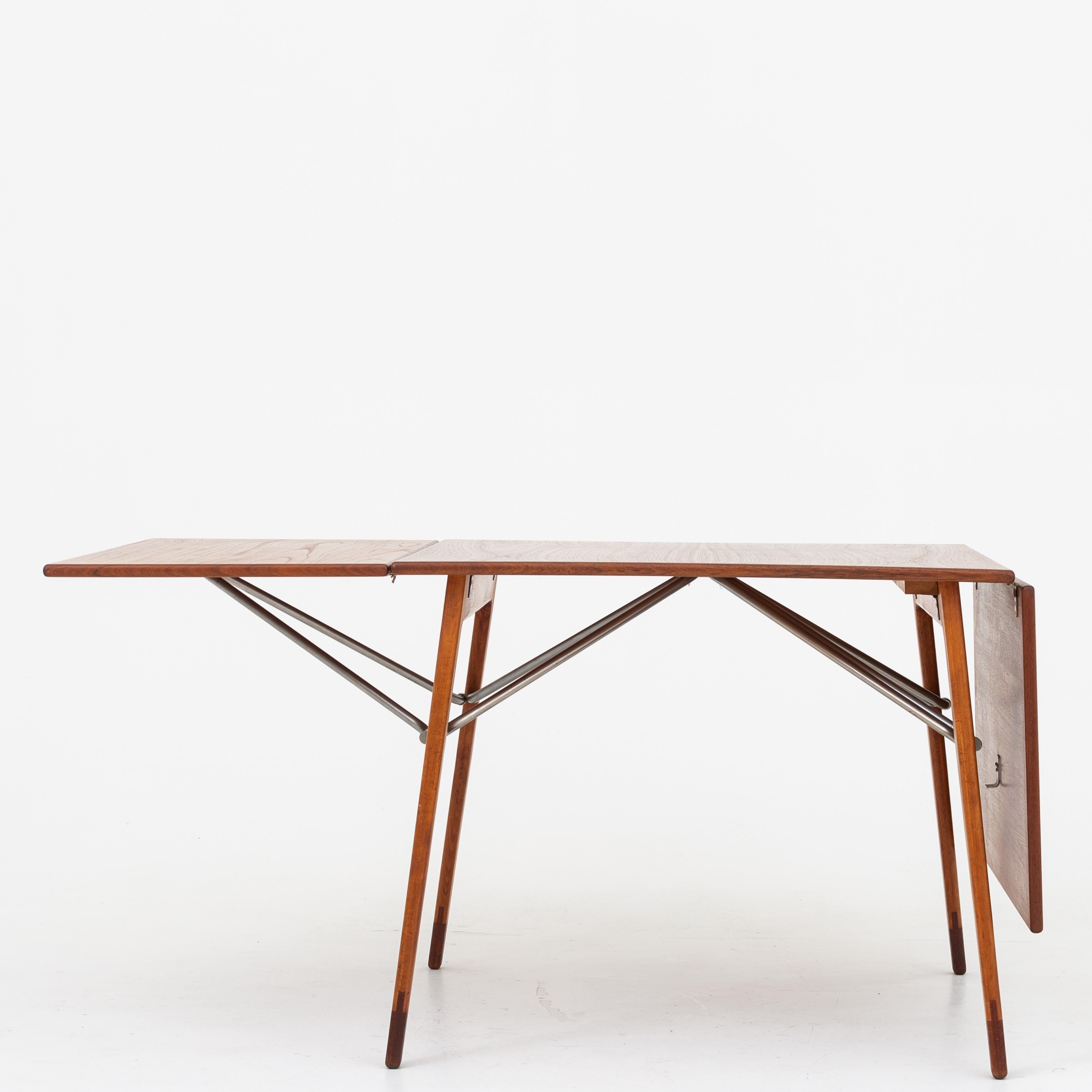 Square dining table or drop-leaf table with beech frame, teak top and teak feet. Steel hangers. Designed in 1952. Maker Søborg Møbelfabrik.