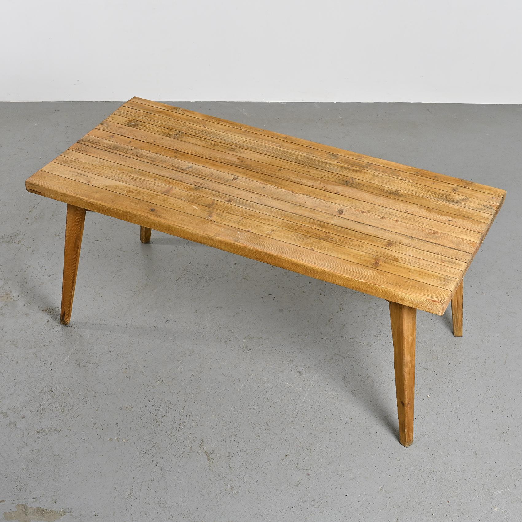 
Dining table by Christian Durupt, originating from the Meribel resort in the French Alps.

The rectangular tabletop, crafted from solid laminated pine, rests on four tapered legs connected by two cross braces.

Provenance: Meribel resort, France,