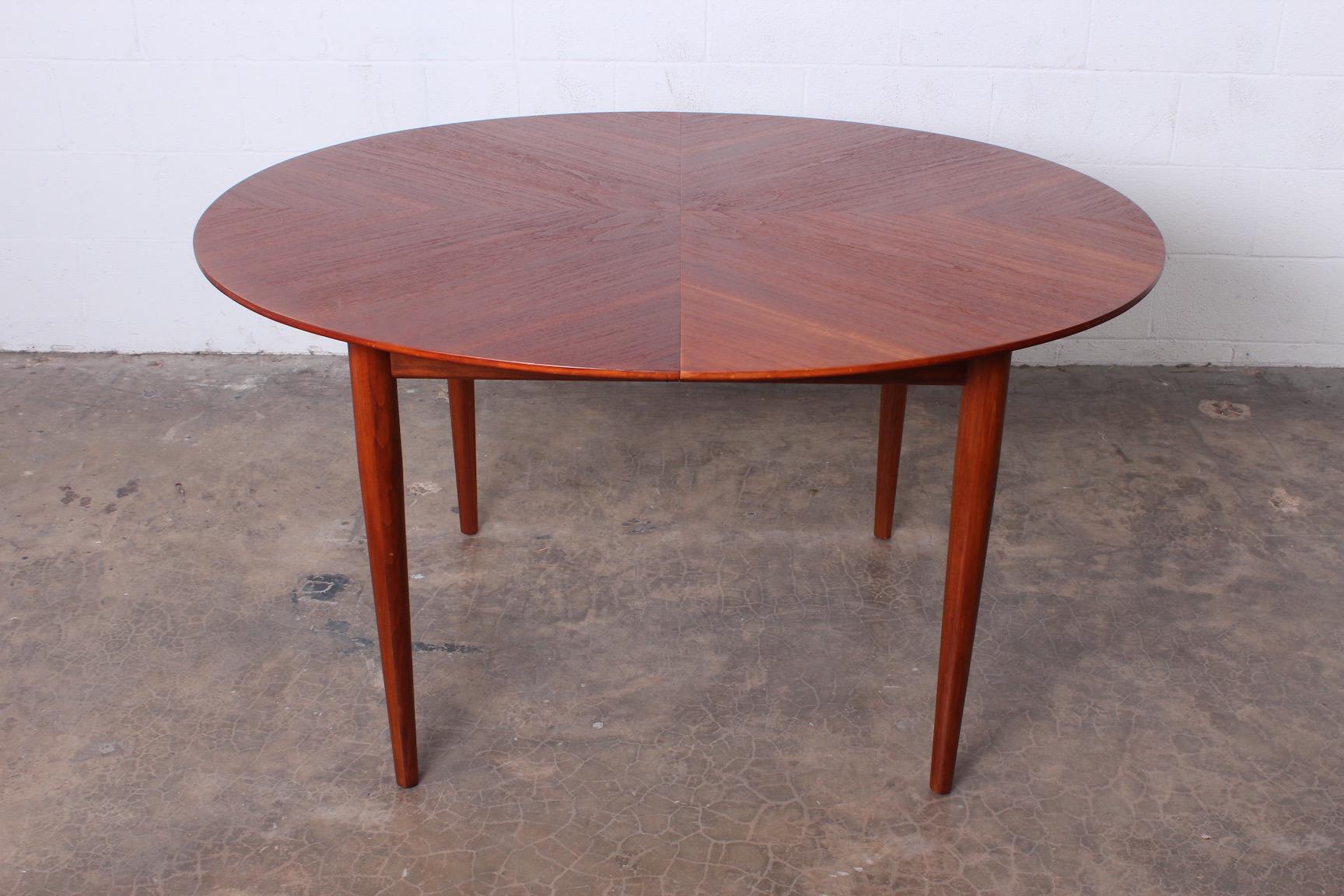 A dining table with three leaves. Designed by Finn Juhl for Baker.