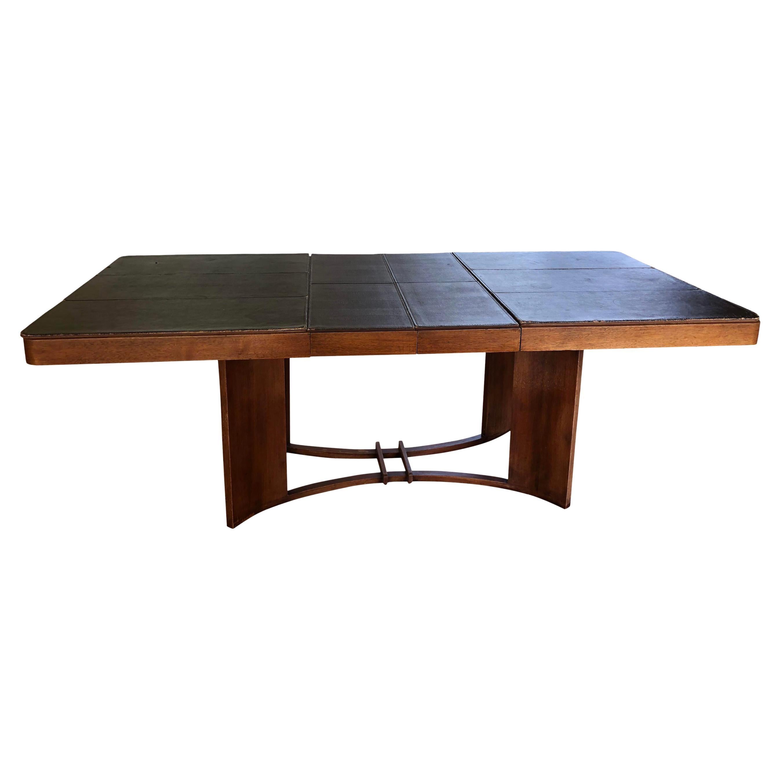 Epic Art Deco dining table by Gilbert Rohde for Herman Miller Furniture Co. (Zeeland, Michigan) circa 1930's. The table is in worn vintage condition with scuffs and blemishes appropriate to its age and use. Proof of maker’s mark on the bottom of the