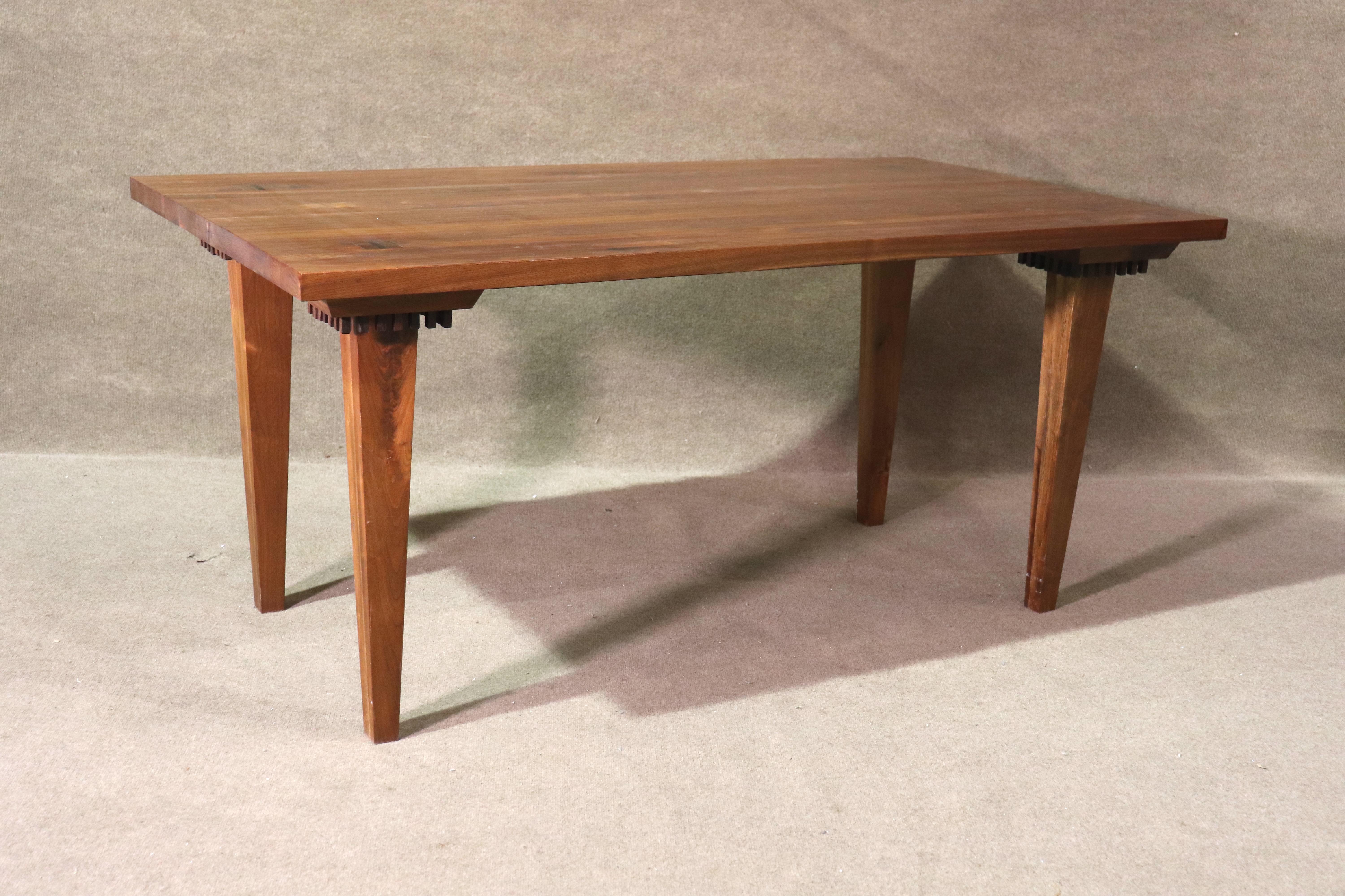 This spectacular table is made from pressed slabs of mixed wood to create a stripe effect, with added rosewood inlay joints. Even the underside has been given thought with rosewood trimming around the tapered legs.
Please confirm location NY or NJ