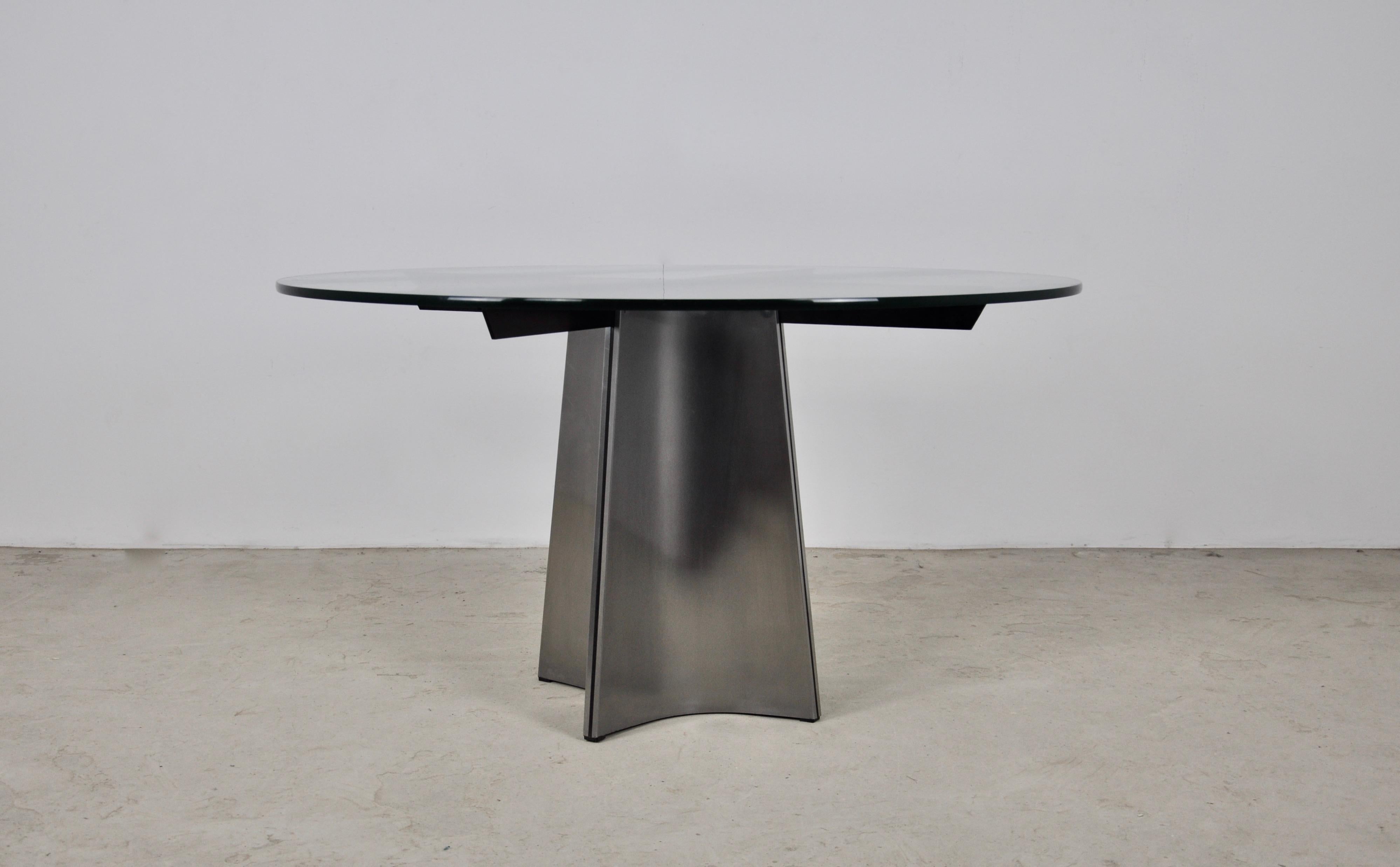 Table with glass top and brushed metal base. Wear due to time and age of the table.