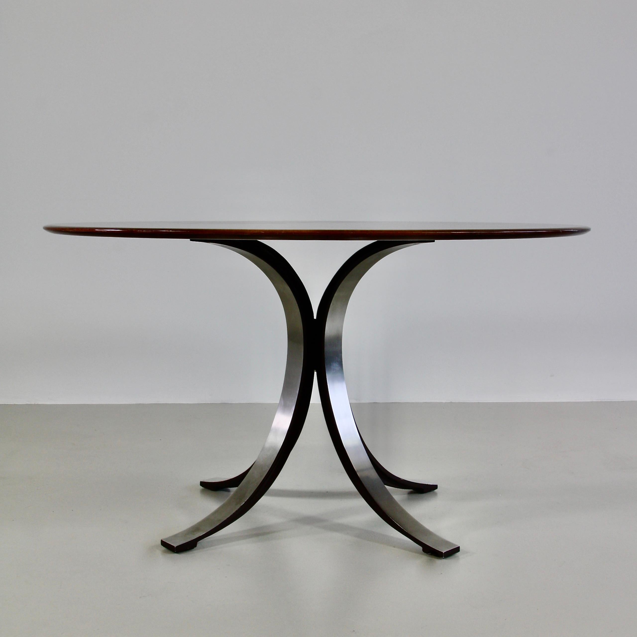 Round dining table (T69A) designed by Osvaldo Borsani in 1963-1964. Produced by TECNO.

Brushed metal base with the inner sides finished in matt dark brown enamel. Original wooden round table top.

Literature:

- Repertorio del Design