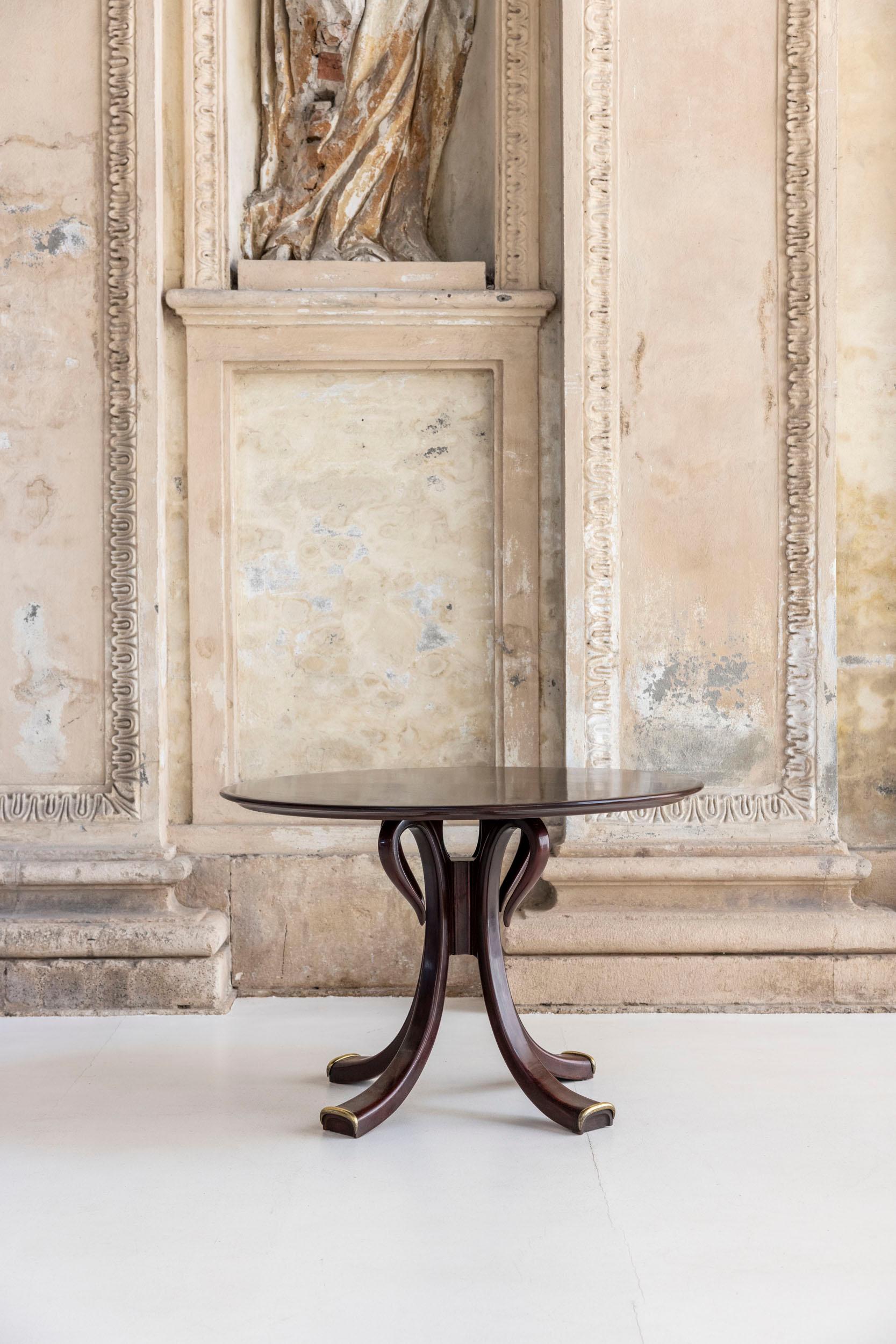 This elegant dining table by Osvaldo Borsani for ABV Arredamenti Borsani Varedo showcases rich dark wood, four sculpted legs, and refined brass accents. The table legs are a signature of Borsani's style.
Published.

Bibliography: G. Bosoni, Osvaldo