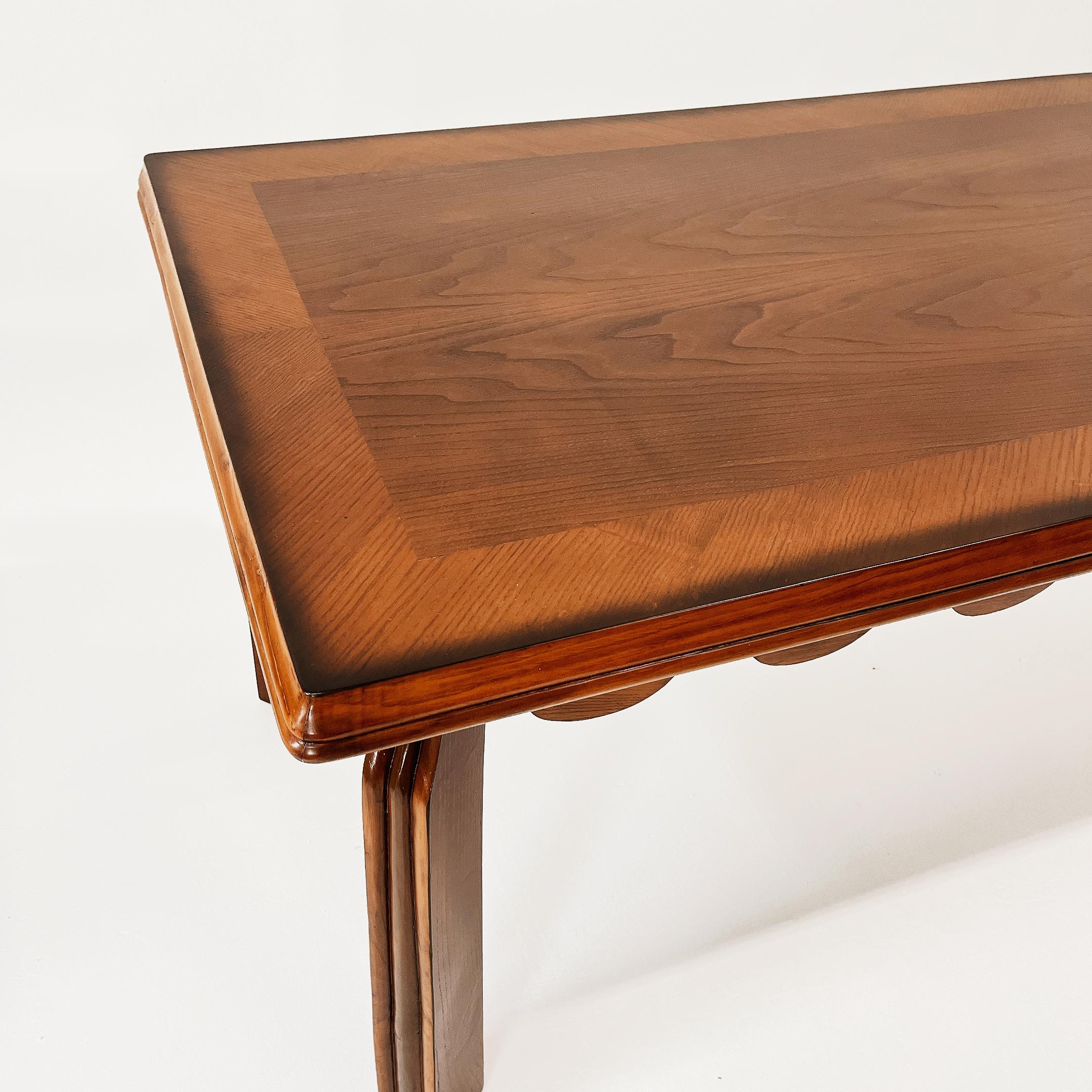 A rare Italian design dining table by Paolo Buffa in Mahogany wood, made in the early 1940's referred as a modern design work. The piece evokes in significant ways the iconic style of Buffa with its scallop carved shapes.