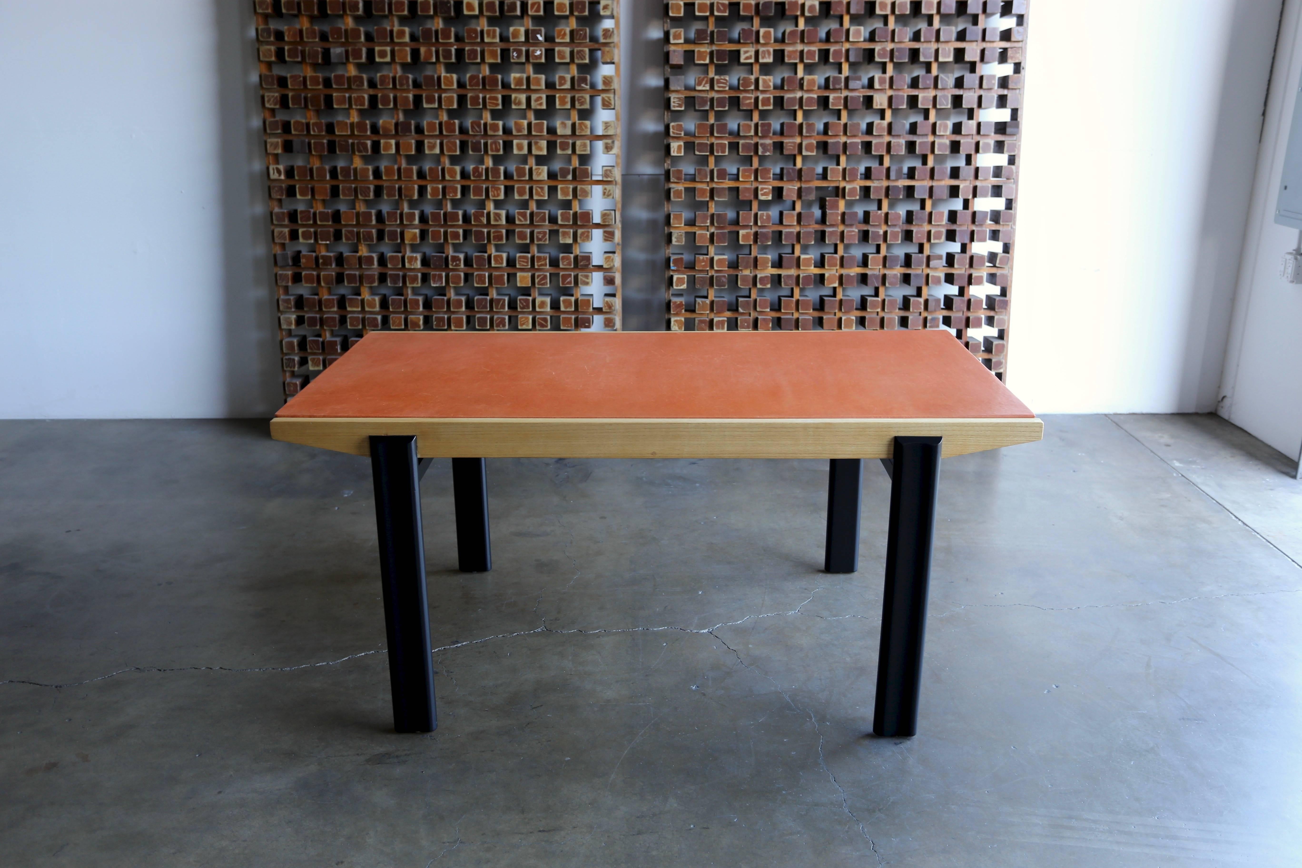 Leather wrapped extension dining or writing table by Pierre Gauriche. This table was manufactured by Airborne International, France, 1950s 

This table measures 94.5