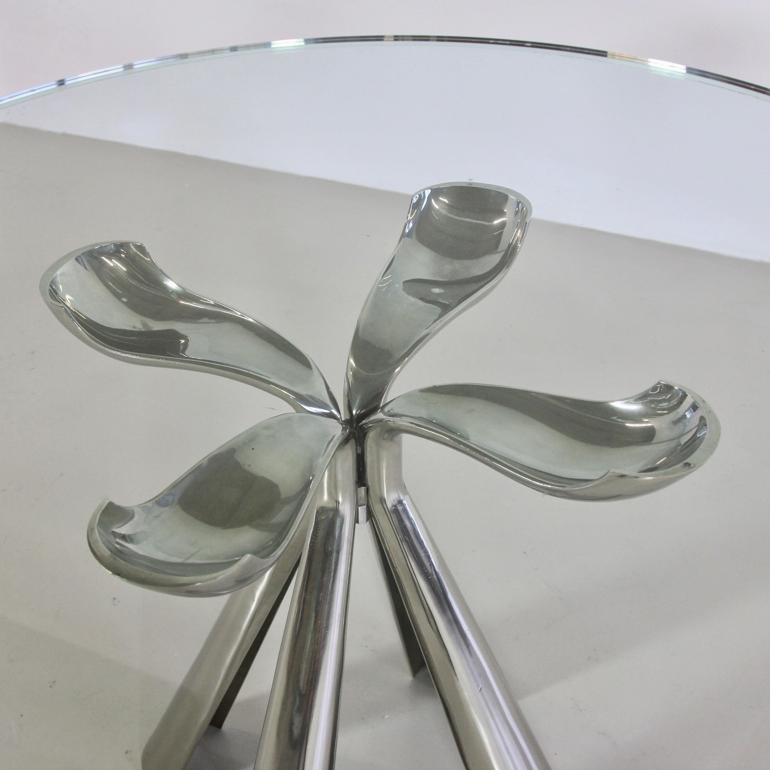 Dining table designed by Vittorio Introini. Italy, Saporiti, 1972.

Cast aluminum base in the shape of a petal with the rare original round glass top including mirrored rim. Model COLBY.
Condition: 

Excellent vintage condition. Original glass