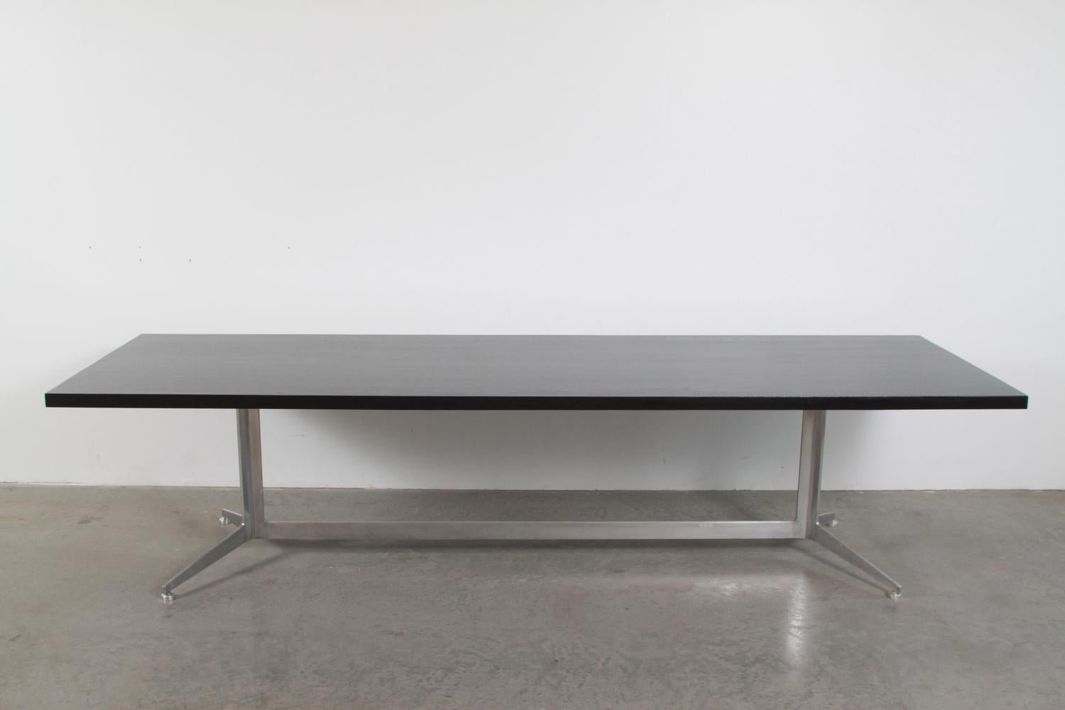 Dining table with ebonized walnut top and aluminum base, designed by Ward Bennett, circa 1967, and produced by Lehigh-Leopold. Table measures 120