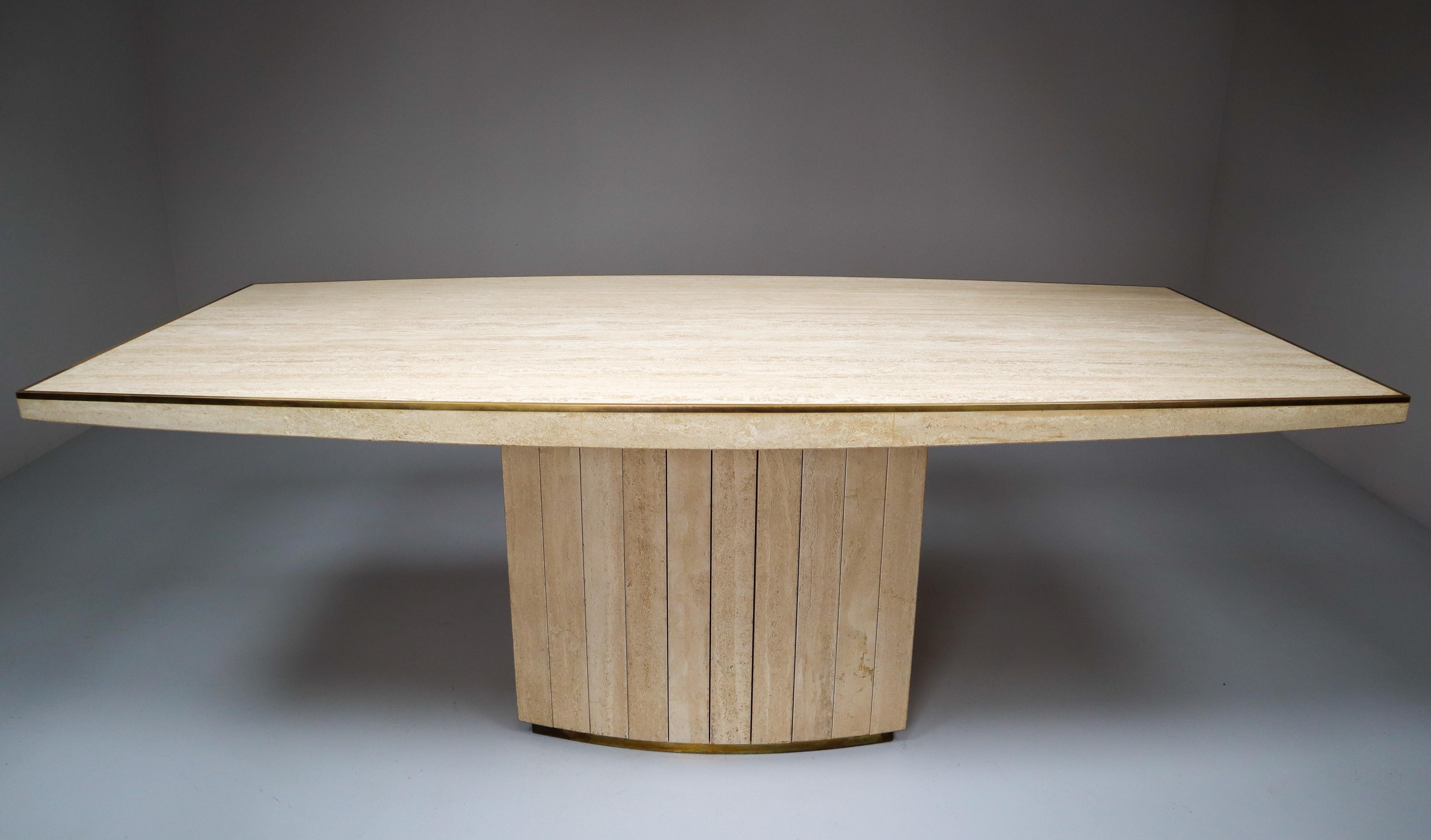 Dining table by Willy Rizzo for Jean Charles, France, 1970s. High quality piece out of travertine and nice solid brass details like the edges around the top and the base. The table has a beautiful curved form and has the right patina. In almost