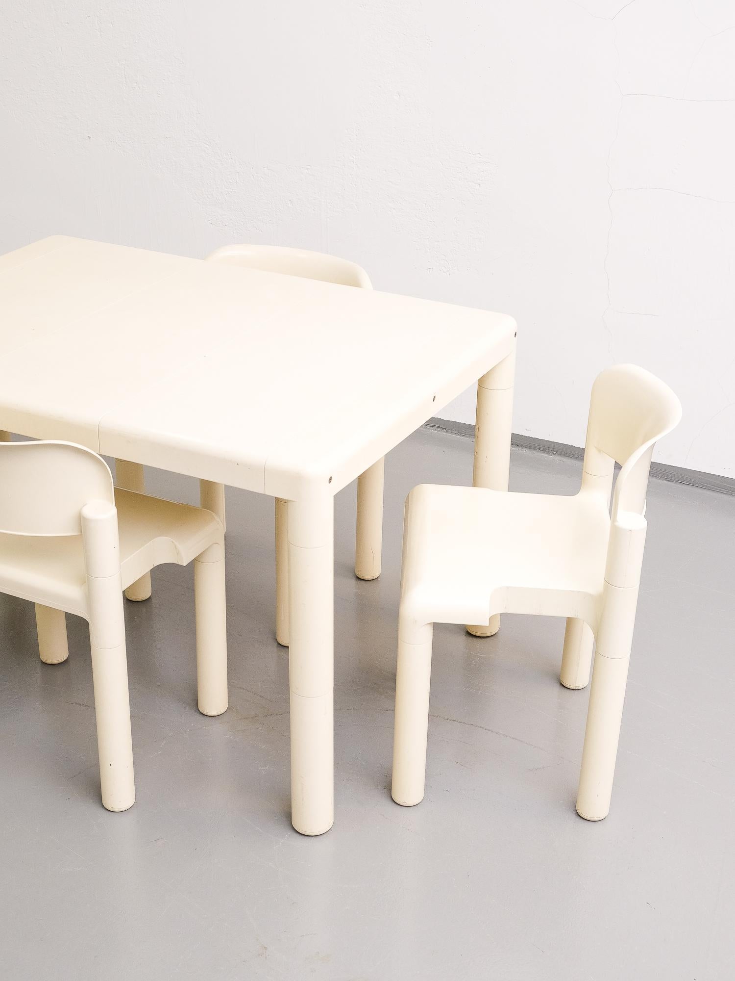 The rare set of 4 stacking chairs with the matching table designed by Eero Aarnio for Upo Furniture, 1970s.
White plastic, metal crossbars beneath the table top to make it sturdy.
The chairs have patina of age. Some signs of use.

Table