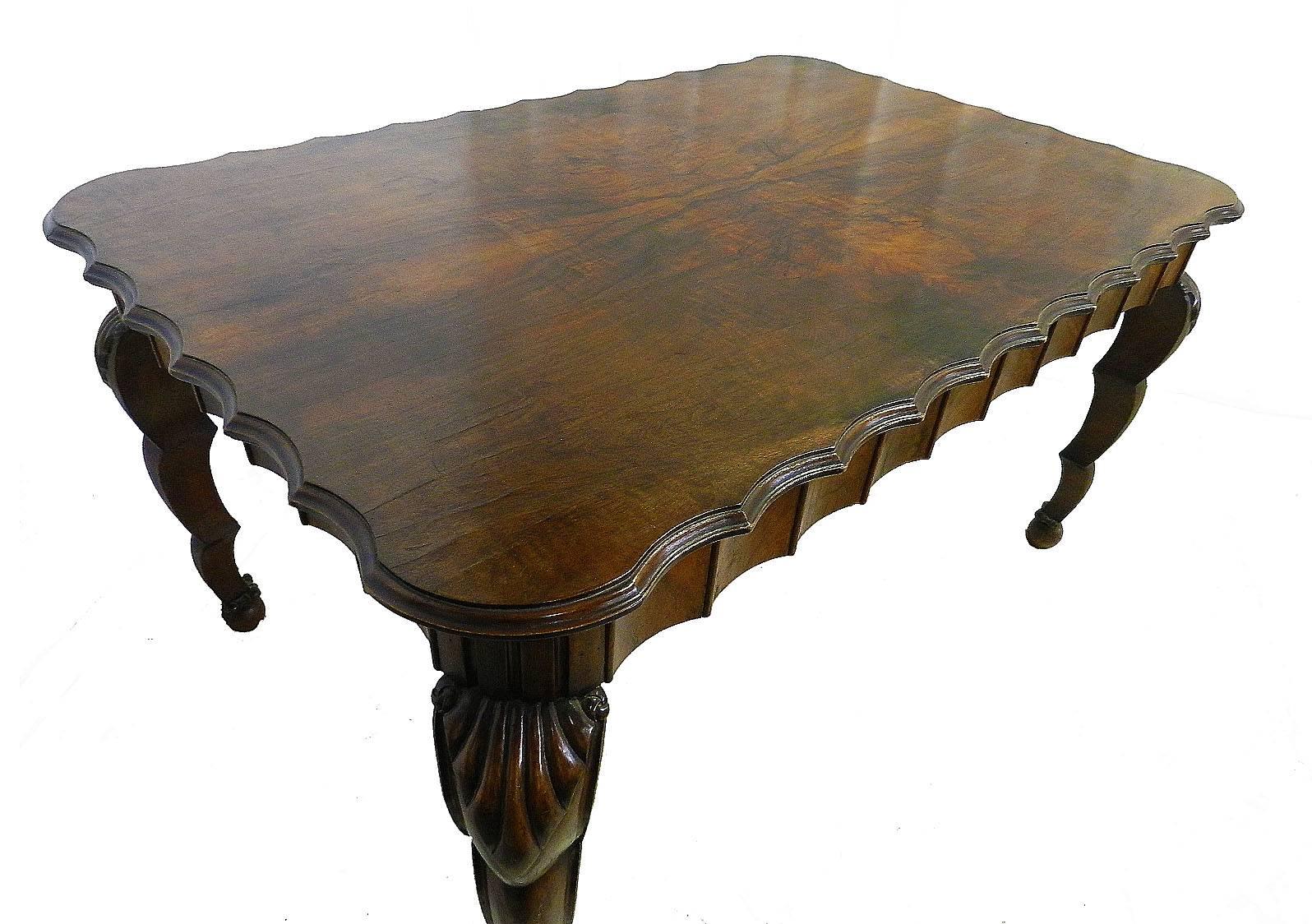 Dining table Art Nouveau Art Deco one of a kind, circa 1910.
Figured burr walnut top
Scalloped edge
Carved dark walnut legs
Italian inspiration from antique grotto shell furniture and reminiscent of early 20th century Hollywood
A very rare find from