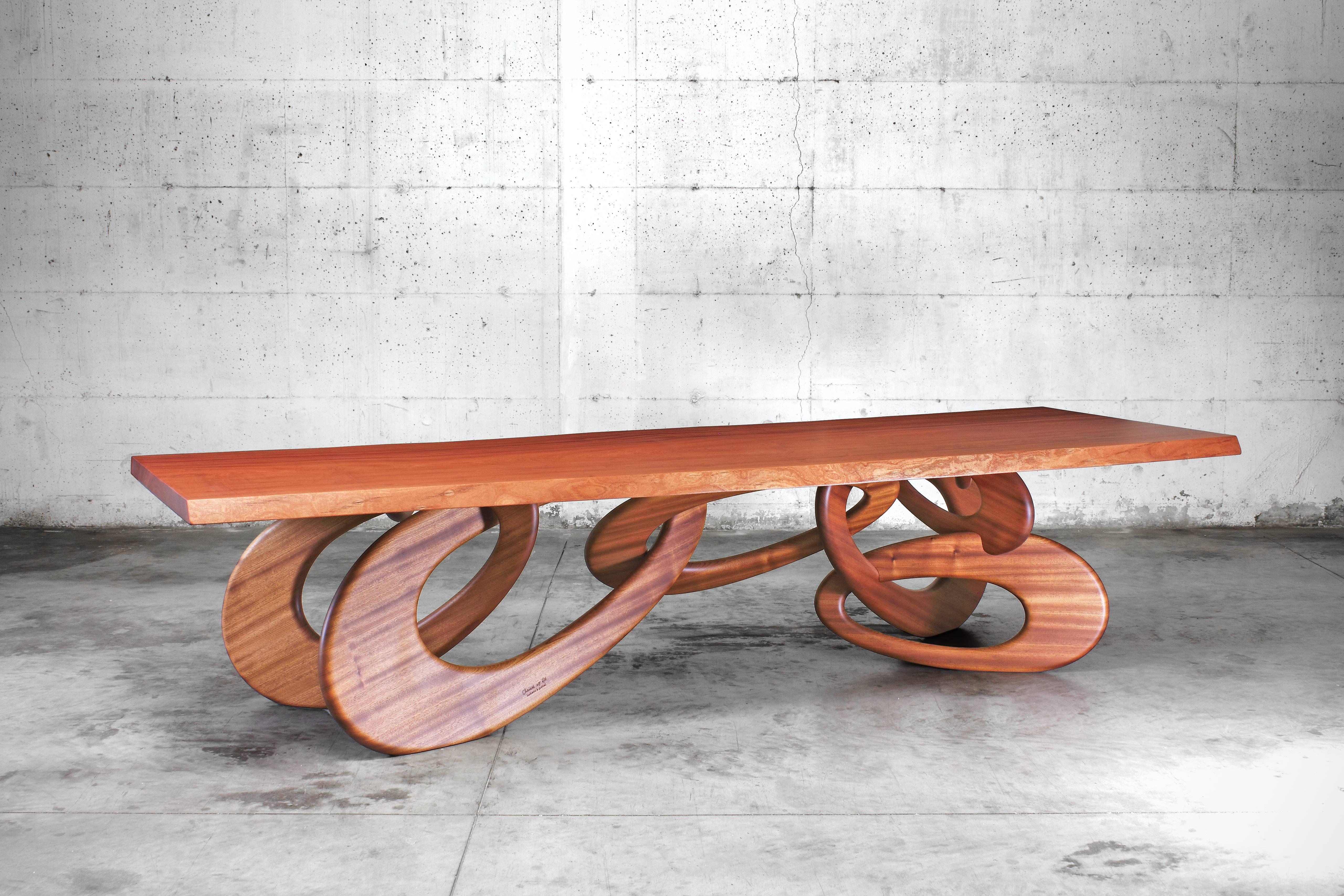 The 'Chained Up' dining table is an important dining table with structure and top in rare one-piece slab mahogany wood (origin: Africa). 

Dining table dimension: L 320 x W 120 x H 76 cm. Dimensions are customizable. 

Limited Edition of 15.

Each