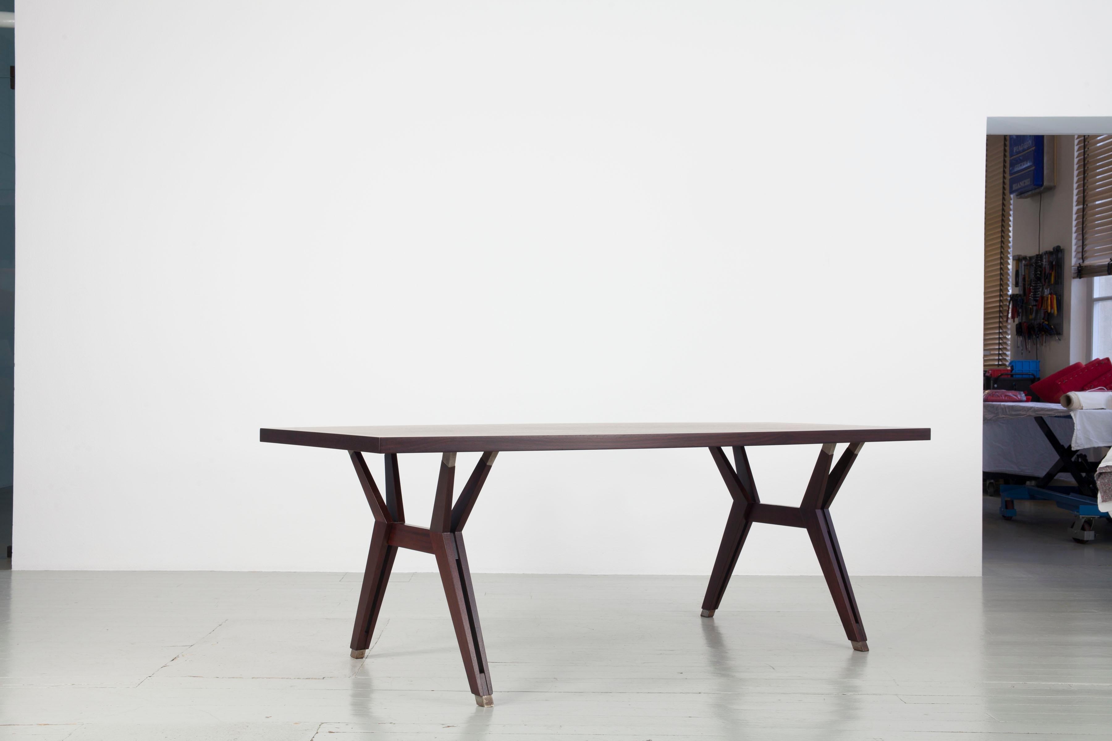 Dining Table - Design by Ennio Fazioli, Manufacturer: M.I.M. - Mobili Italiani Moderni, Italy, 1960s
Constructed of a rosewood veneer tabletop and mahogany table legs, this table was designed by Ennio Fazioli as a variation of a design by Ico
