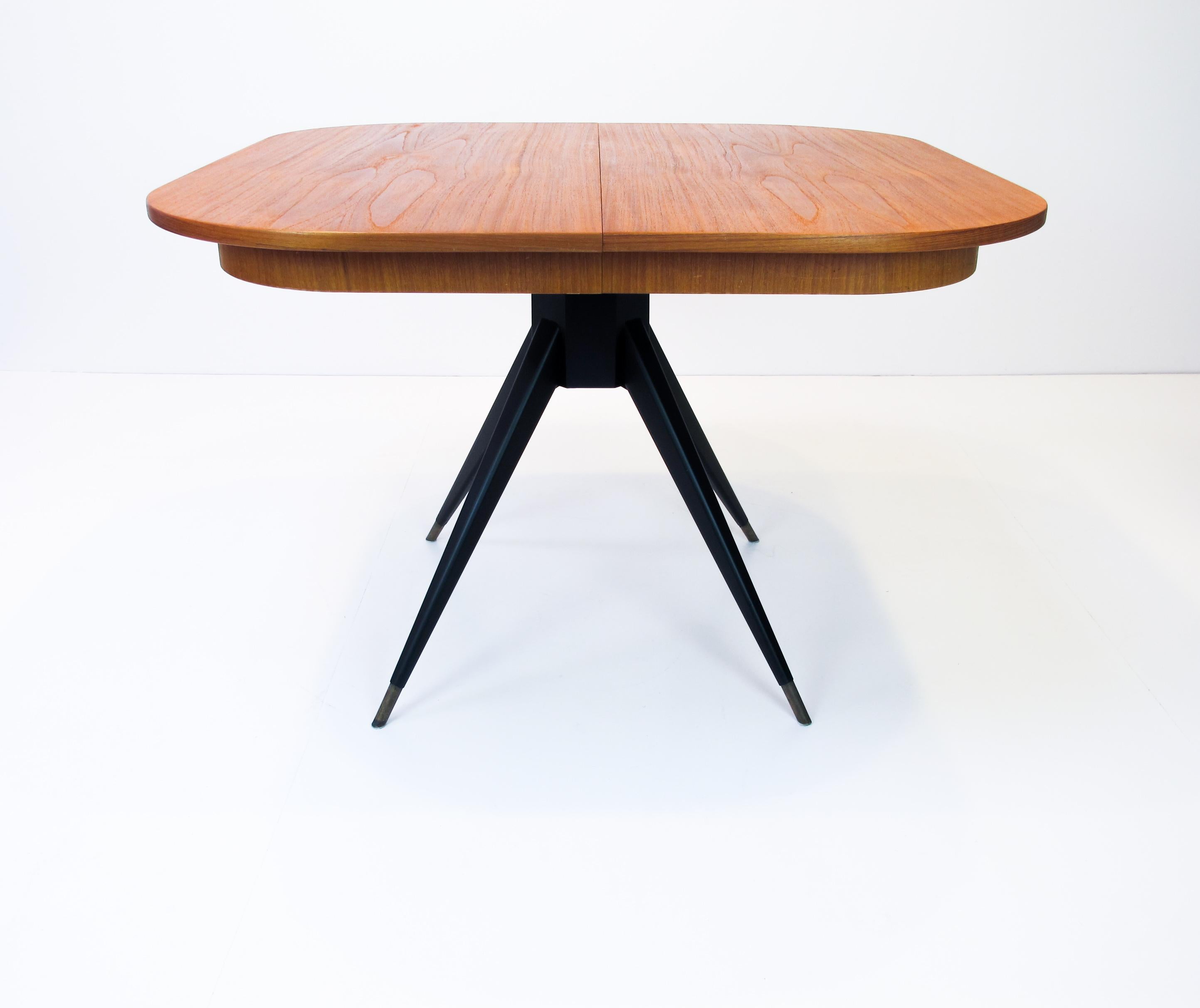 This dining table was designed by Svante Skogh for Seffle Mobelfabrik. 
It's made of teak with black lacquered legs. The extension leafs measure 35cm (x2).

Measurement with one leaf, 105 x 140 cm 
Measurement with two leafs, 105 x 175 cm.
  