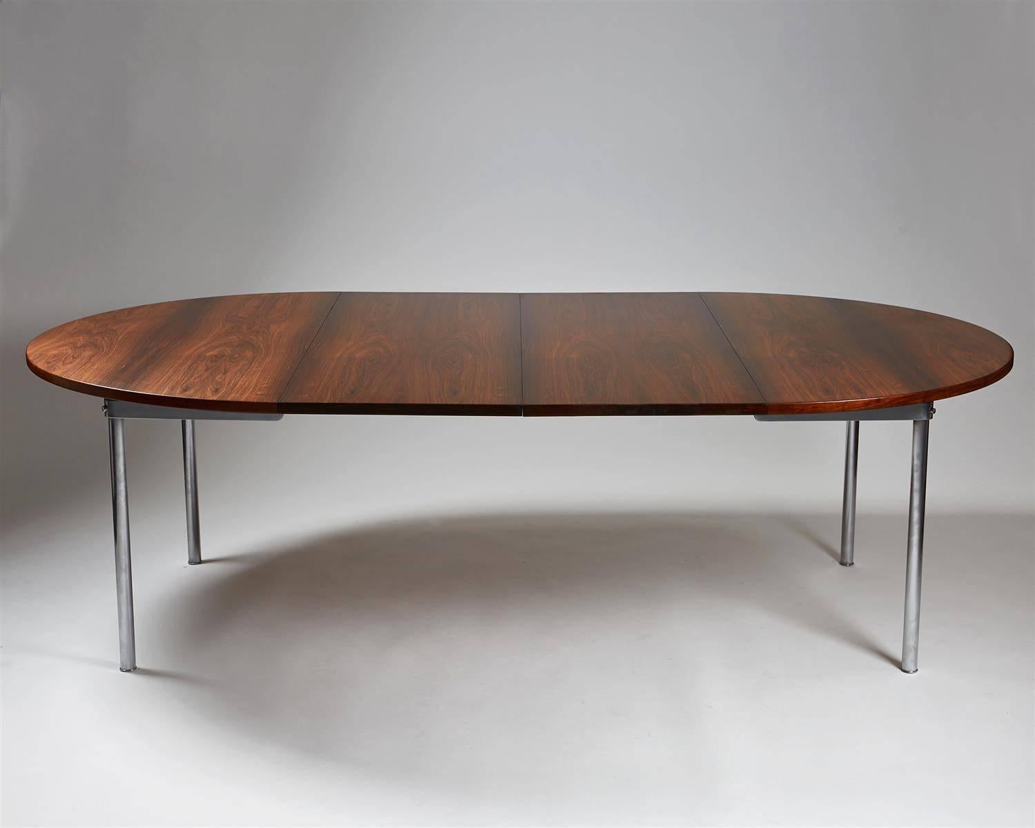 Dining table designed by Hans Wegner for Andreas Tuck, Denmark, 1961. Rosewood and brushed steel. 

Measures: H 70.5 cm / 27 3/4''
D 135 cm / 53 1/4''
Total length 235 cm / 7'9''
Two extension leaves at 50 cm / 19 3/4'' each.