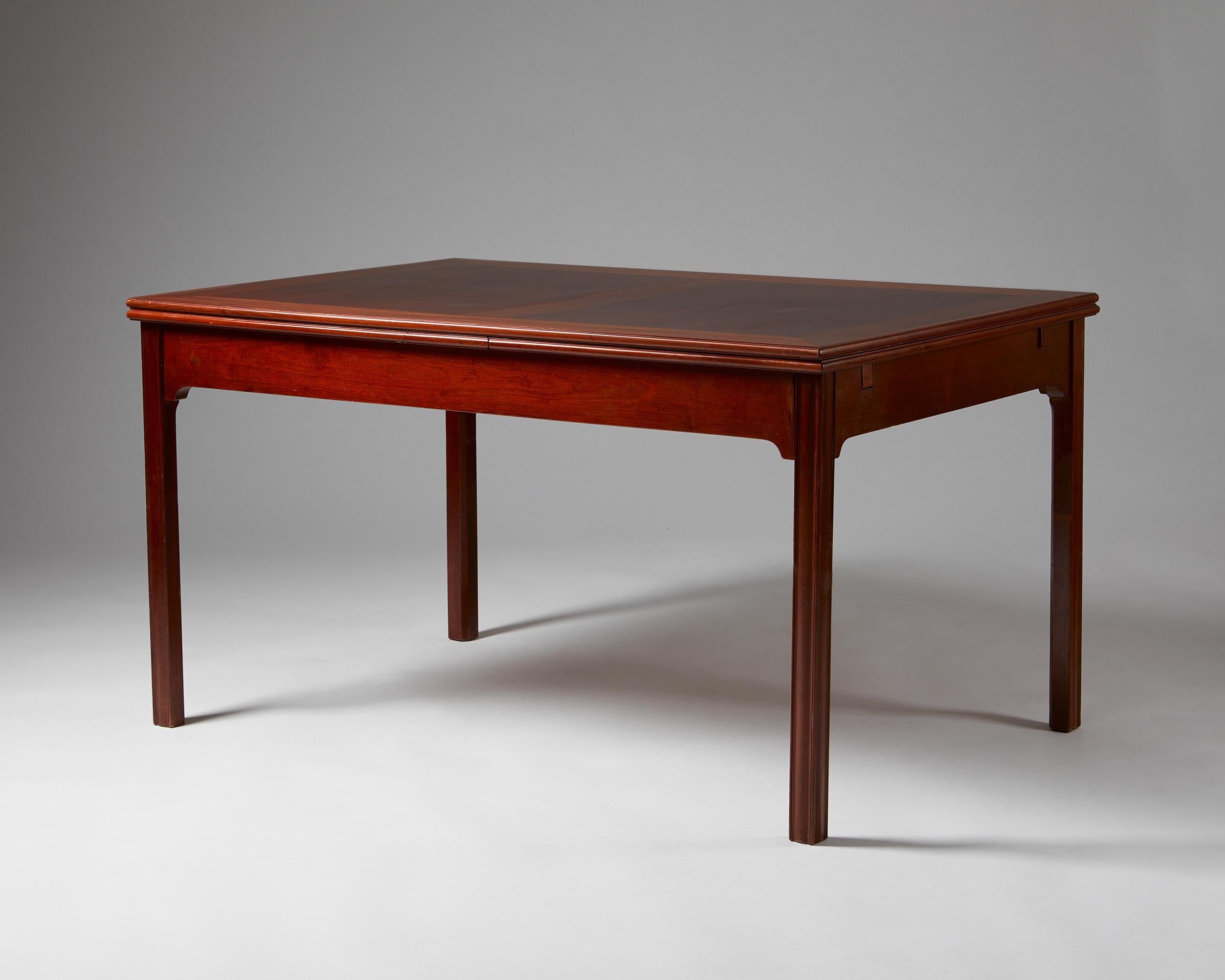 Dining table designed by Kaare Klint for Rud. Rasmussen,
Denmark. 1930s.
Mahogany.

Stamped.

This model is one of the rarest and finest dining tables by the Danish master Kaare Klint. Carefully chosen woodgrain textures frame each part of the