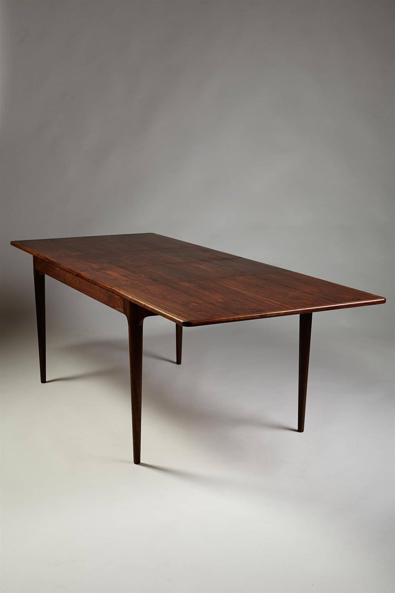 Dining table, designed by Mogens Kold, Denmark. 1960’s.

Brazilian rosewood.

Measurements:
Height: 73 cm/ 28 3/4''
Length when closed: 135 cm/ 53''.
Two extension leaves at 45 cm/ 17 3/4'' each.
Width: 90 cm/ 35 1/2''