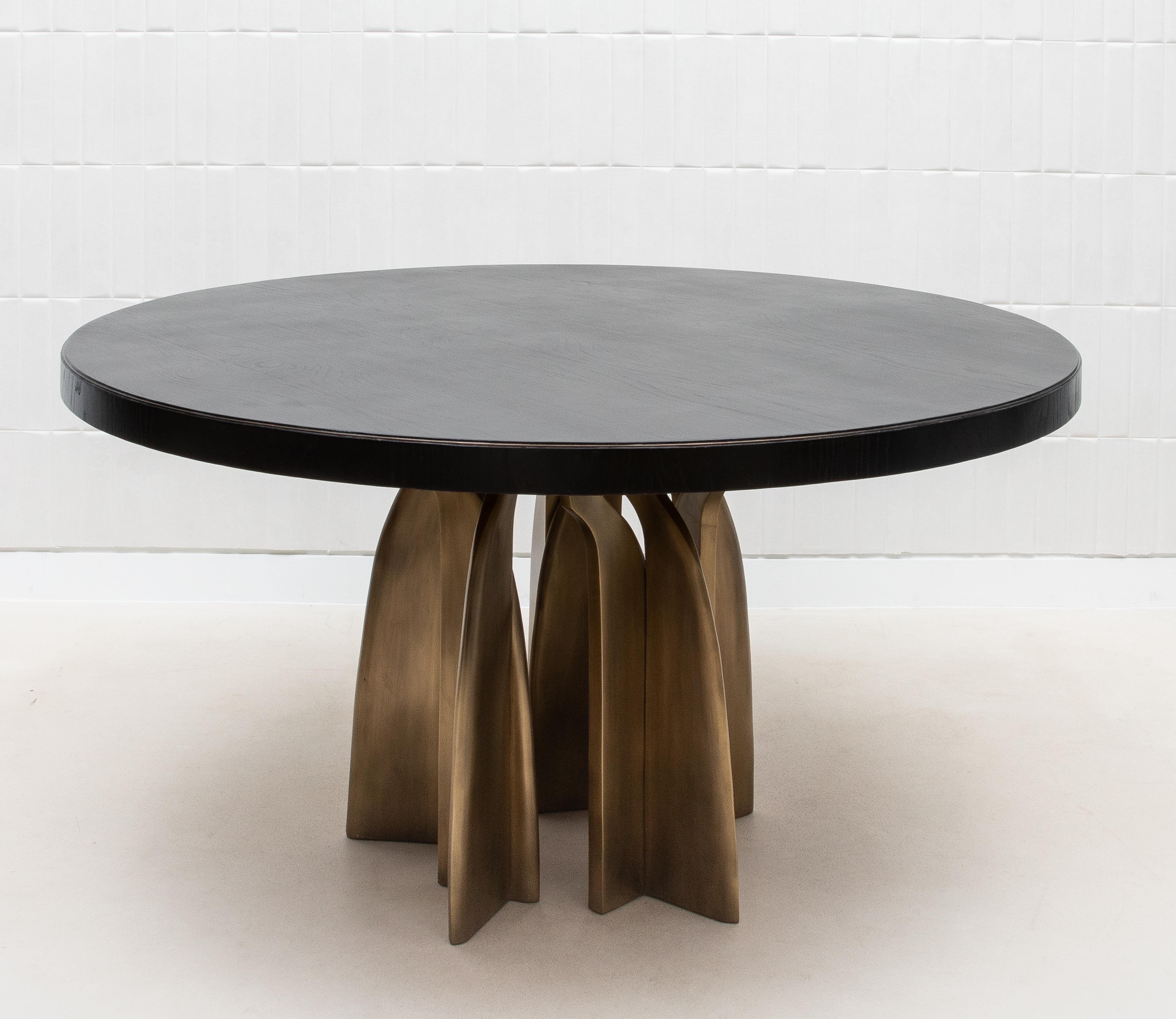 The Chital Dining Table by Kifu Paris in black oak is a true testament to the fusion of modern design and luxurious craftsmanship. The table's top, meticulously crafted from rich black oak, exudes a deep, natural elegance that is beautifully