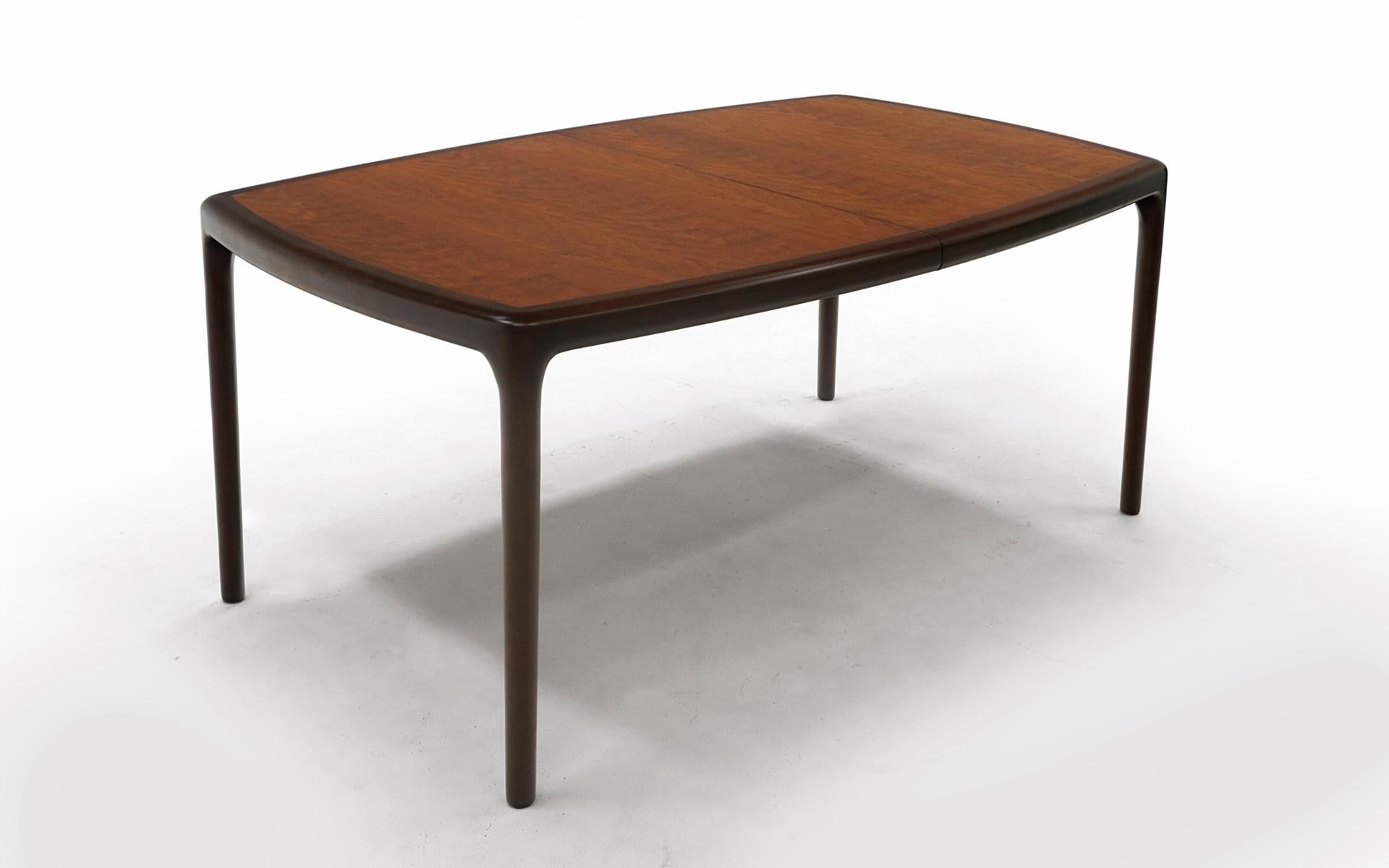 Edward Wormley for Dunbar dining table in Cherry and Mahogany. Expertly refinished. The condition is as close to perfect as it can get. Leaves are 18 inches wide. Table is 66 inches wide without leaves.