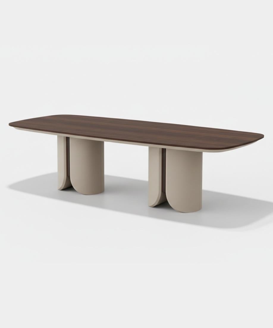 This dining table features a refined and contemporary design, blending luxurious materials with minimalist architecture. Its two sculptural legs are finished in a high-gloss lacquer, creating a sleek and modern base. The tabletop, crafted from