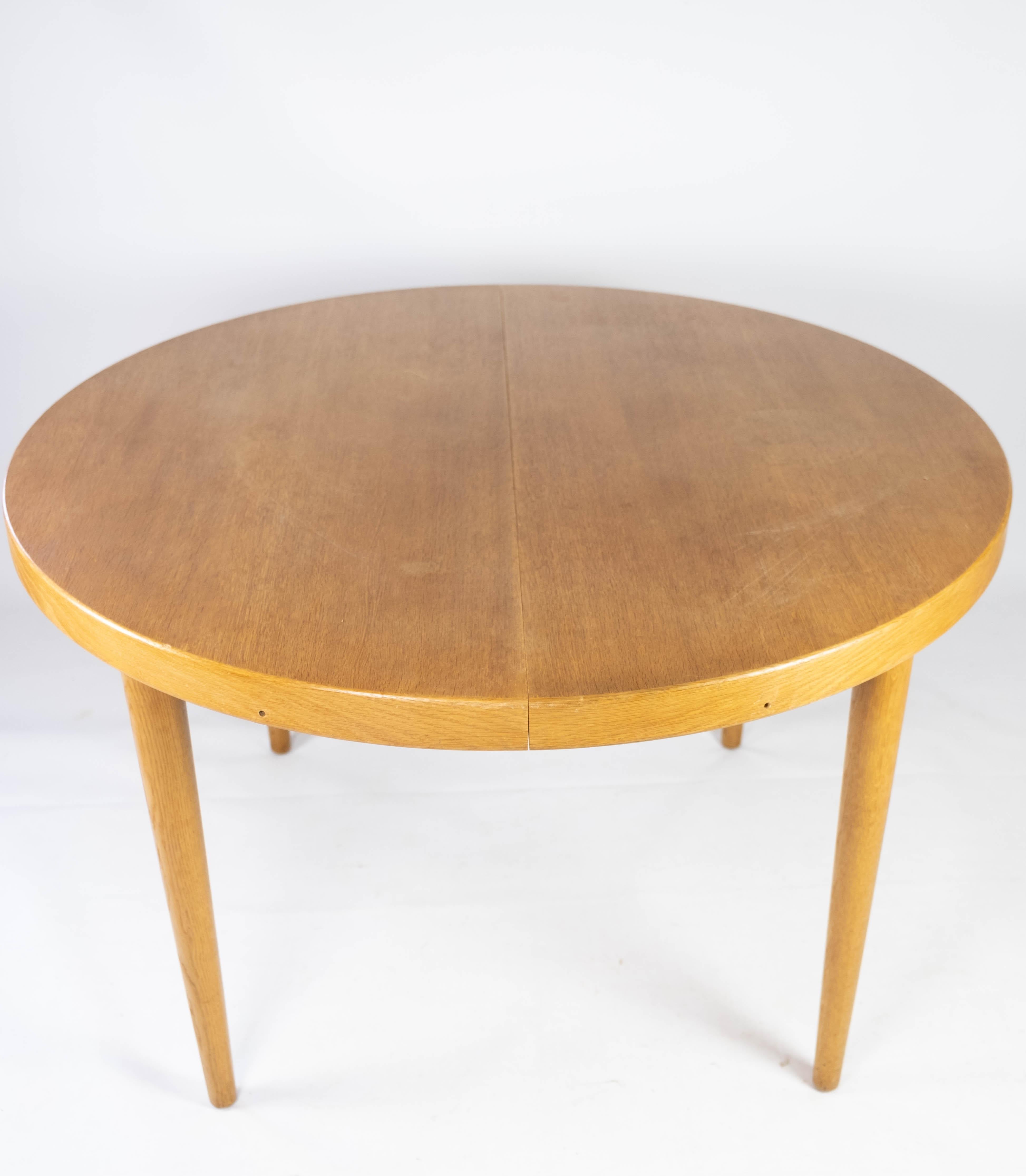 This dining table, designed by Omann Junior in the 1960s, embodies the essence of Danish mid-century modern design. Crafted from light wood, its clean lines and minimalist silhouette exude a sense of timeless elegance, making it a versatile addition