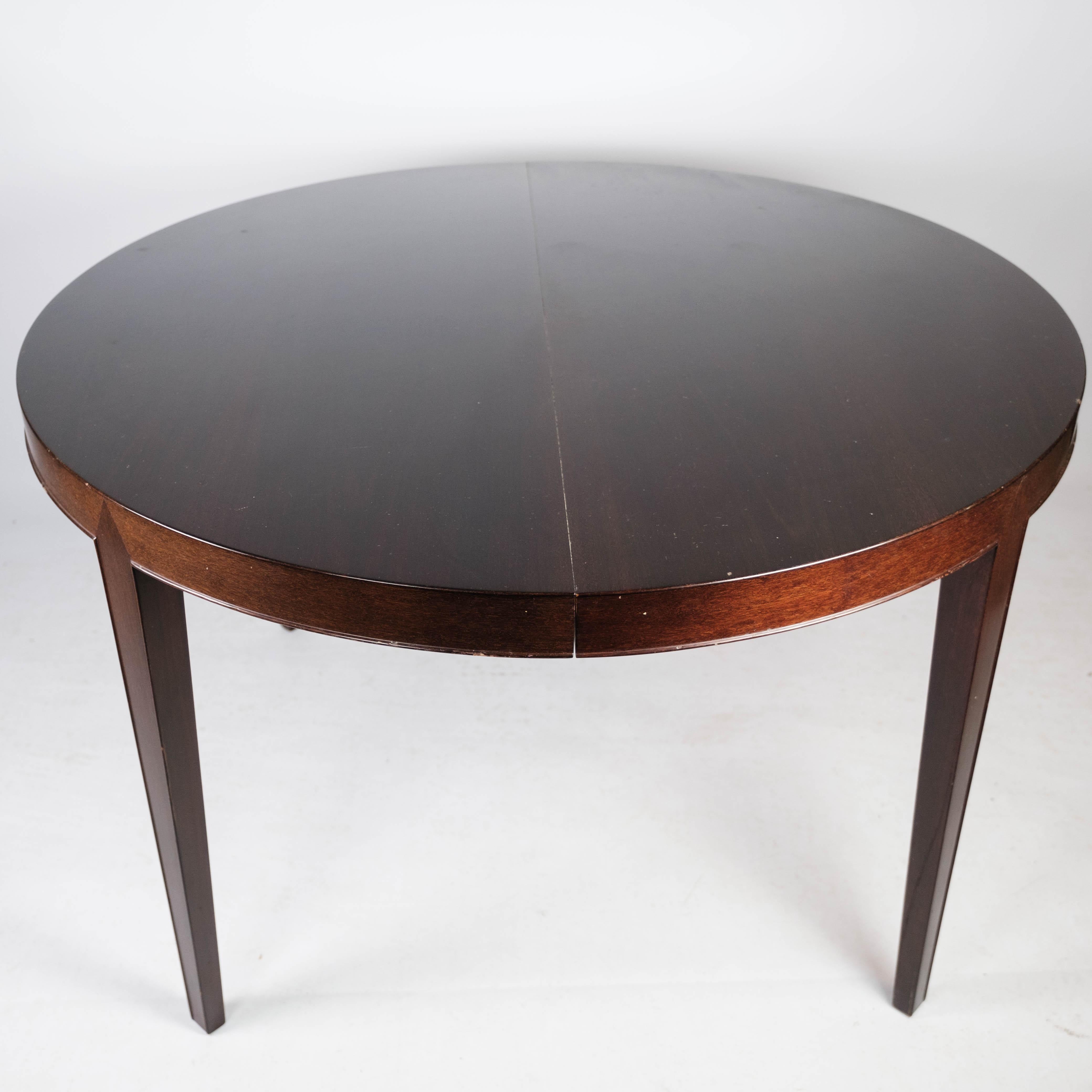 Dining table in mahogany with three extension plates, of Danish design manufactured by Haslev Furniture in the 1960s. The table is in great vintage condition. 
Extentions are 50 cm each.