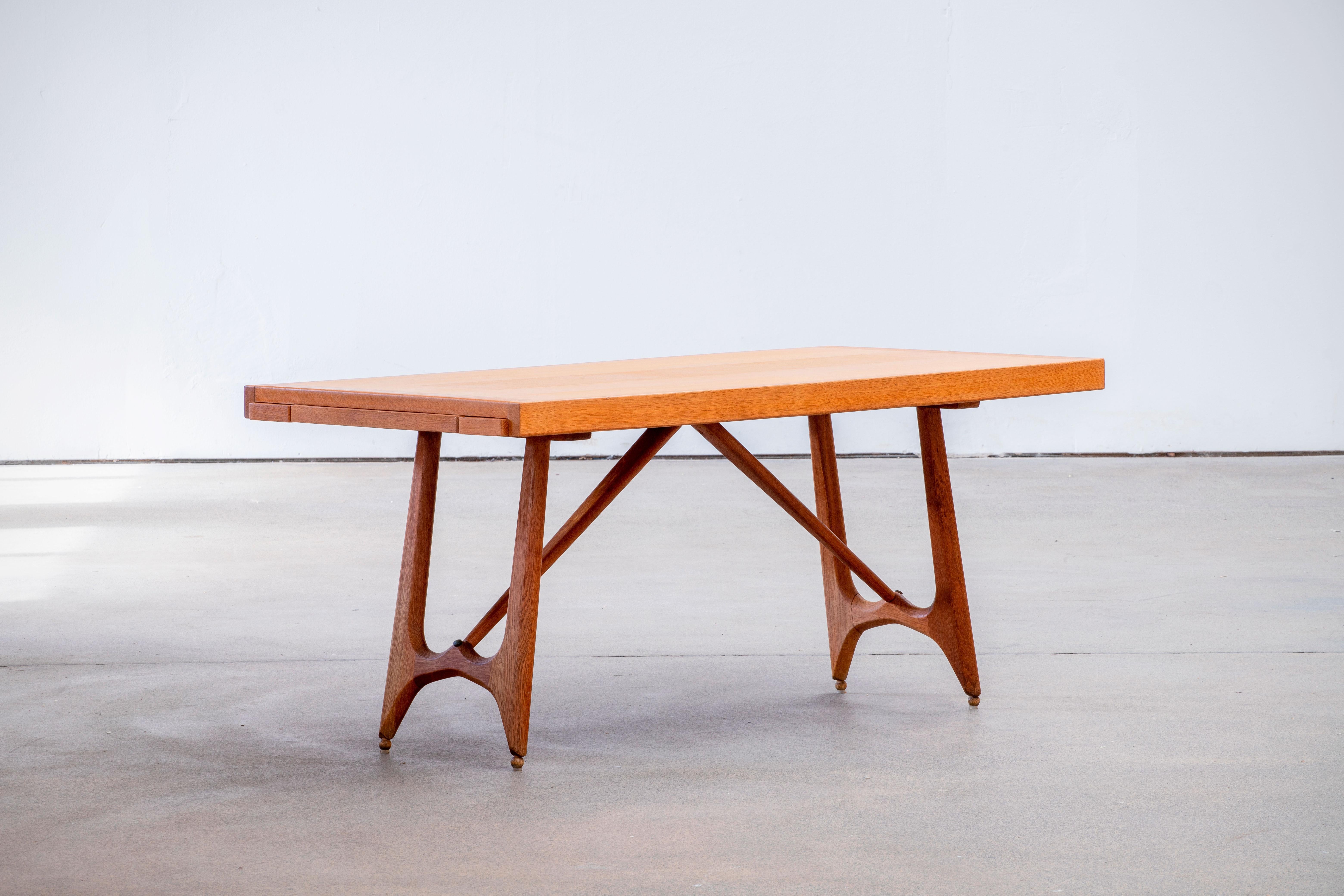 Extendable dining table by French designer duo Jacques Chambron and Robert Guillerme. The legs of this table are beautifully shaped and show nice organic forms. The top is rectangular with to extendable leaves. The leaves are 'hidden' under the top