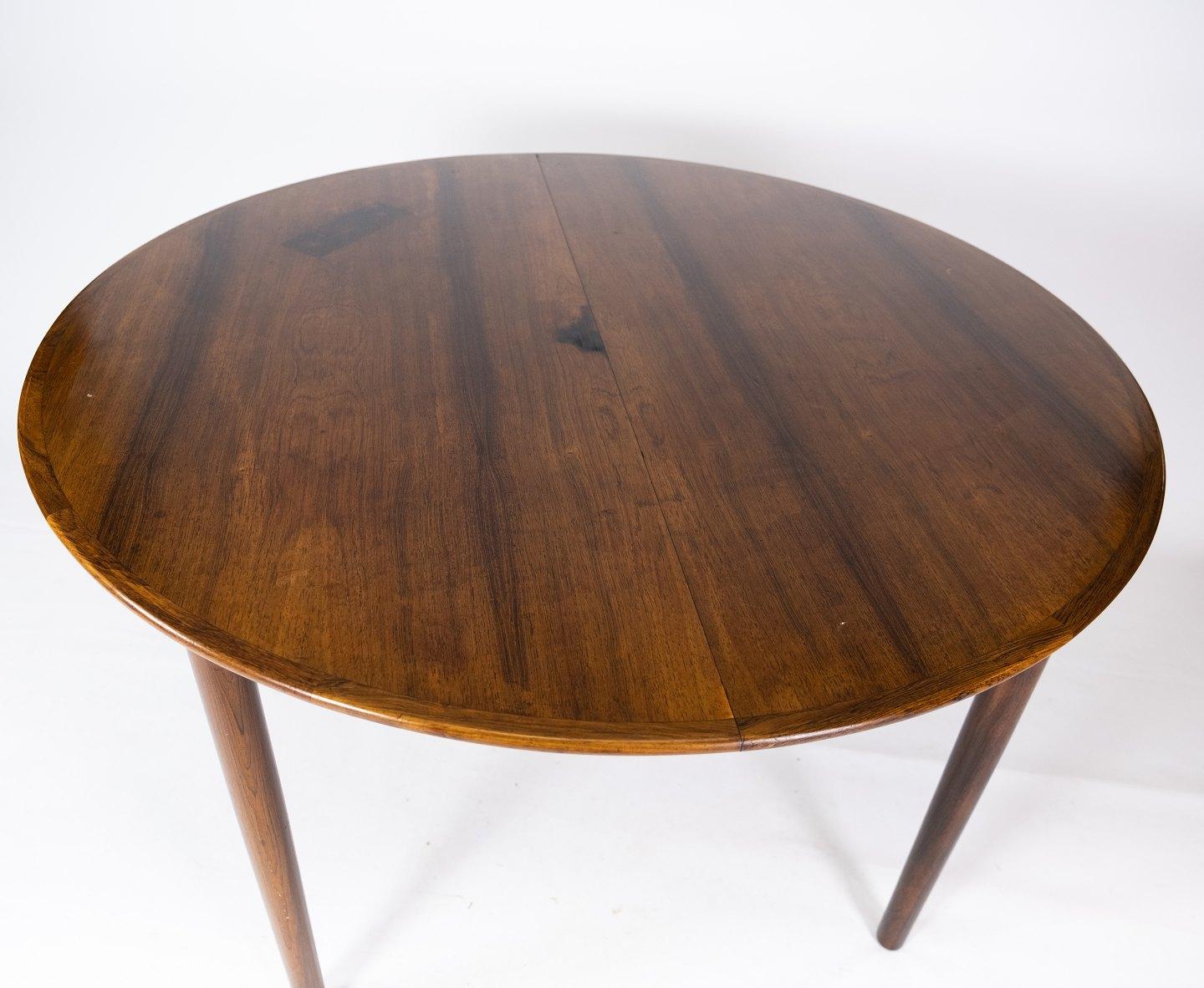 This rosewood dining table, designed by Arne Vodder in the 1960s, is a remarkable example of Danish furniture design from this era. The warm colors and beautiful patterns of the rosewood give the table an elegant and sophisticated appearance that