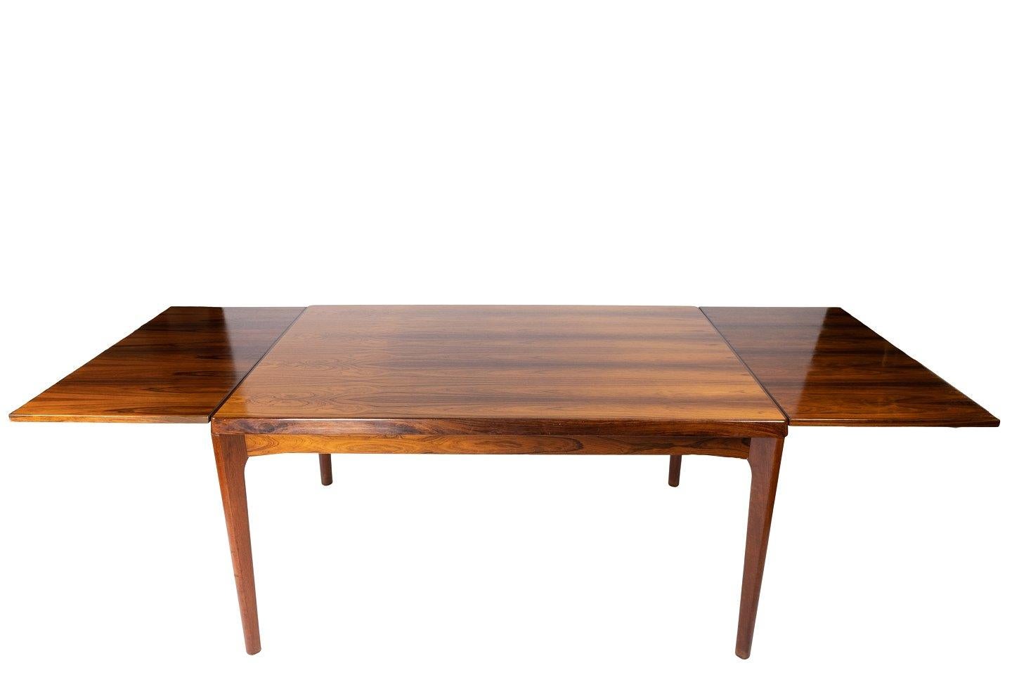 Dining table in rosewood with extensions designed by Henning Kjærnulf and manufactured by Vejle Furniture Factory in the 1960s. The table is in great vintage condition.