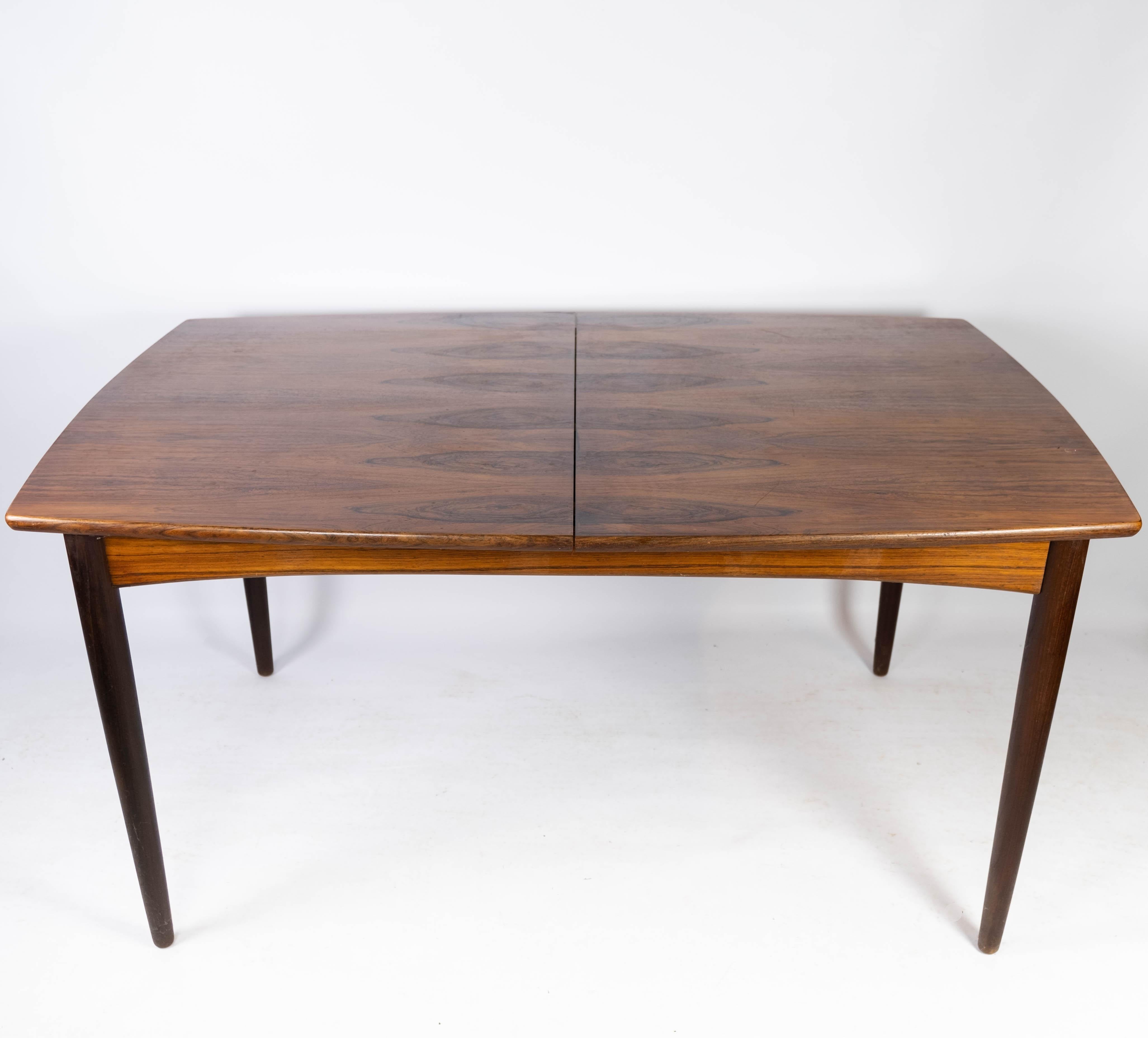 Dining table in rosewood with extensions, of Danish design from the 1960s. The table is in great vintage condition. 
Measurements with extention are 256 cm.