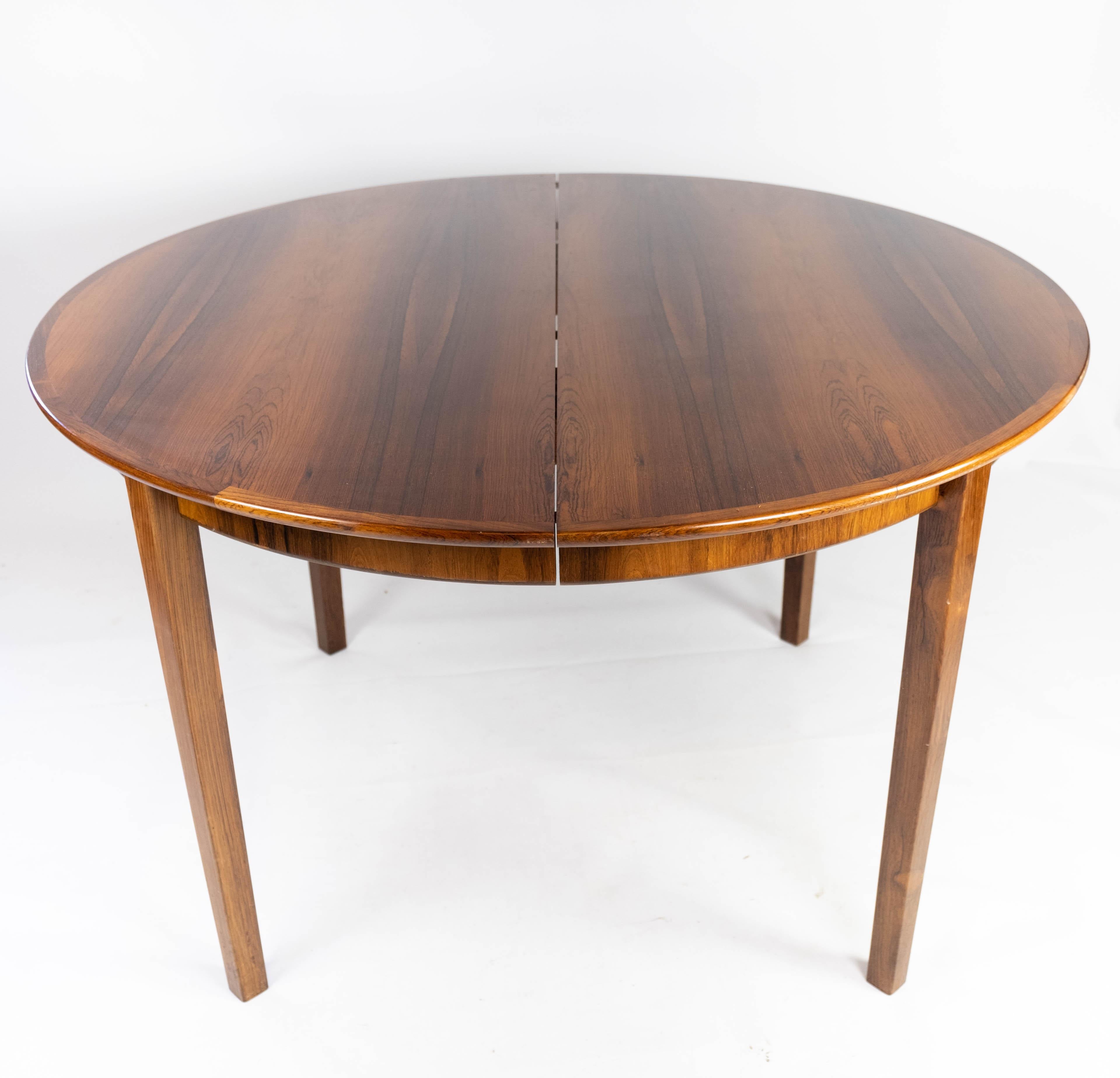 This dining table, crafted from luxurious rosewood, embodies the elegance and functionality of Danish design from the 1960s. Its sleek lines and minimalist silhouette reflect the modern aesthetic of the era, while the rich tones and intricate grain