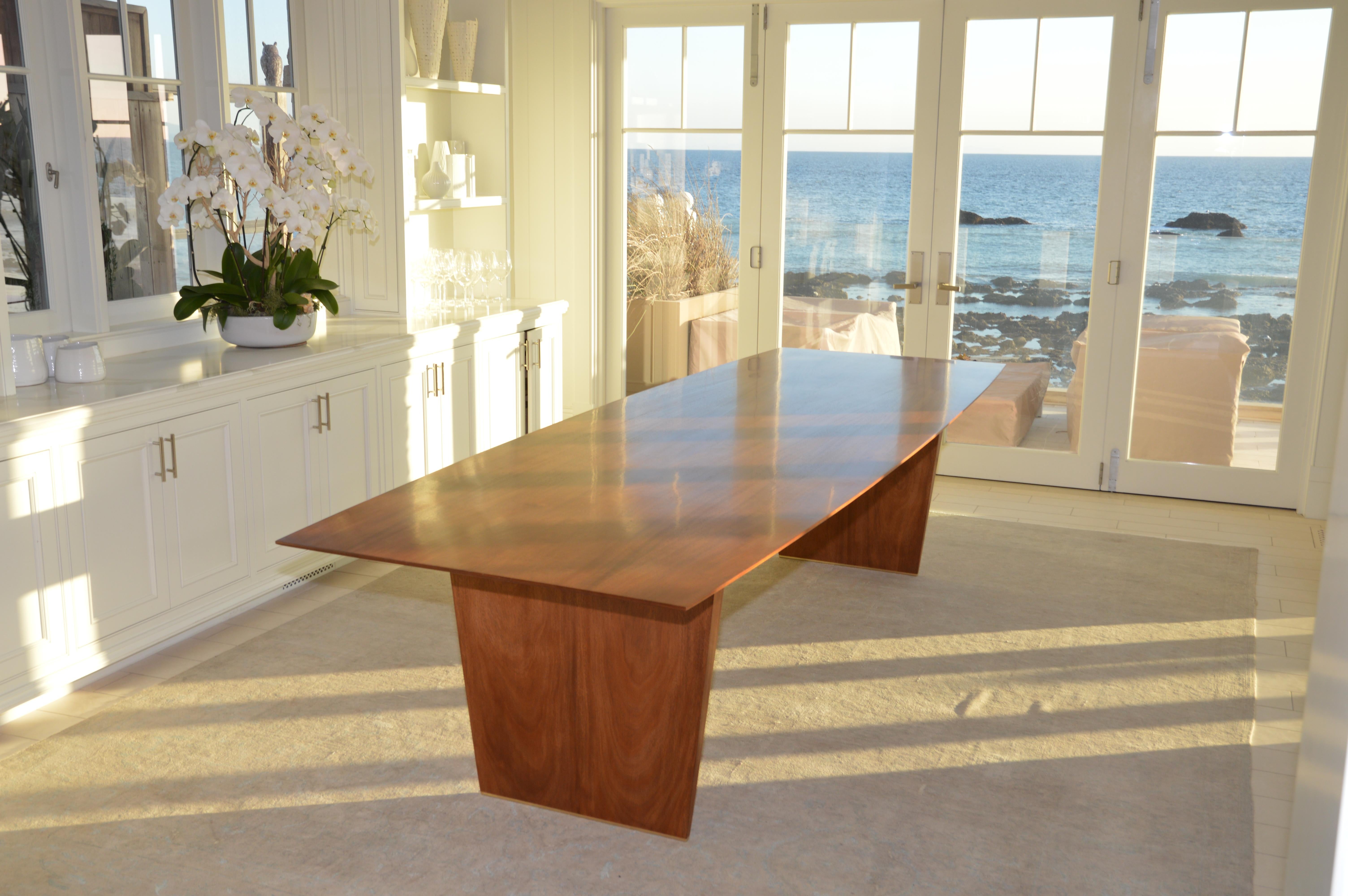 This dining table is made from solid, book-matched African mahogany. Both the top and the legs are book-matched to create a perfectly symmetrical pattern in the wood grain. We designed this table in collaboration with Lauren Gurwich, and with a nod