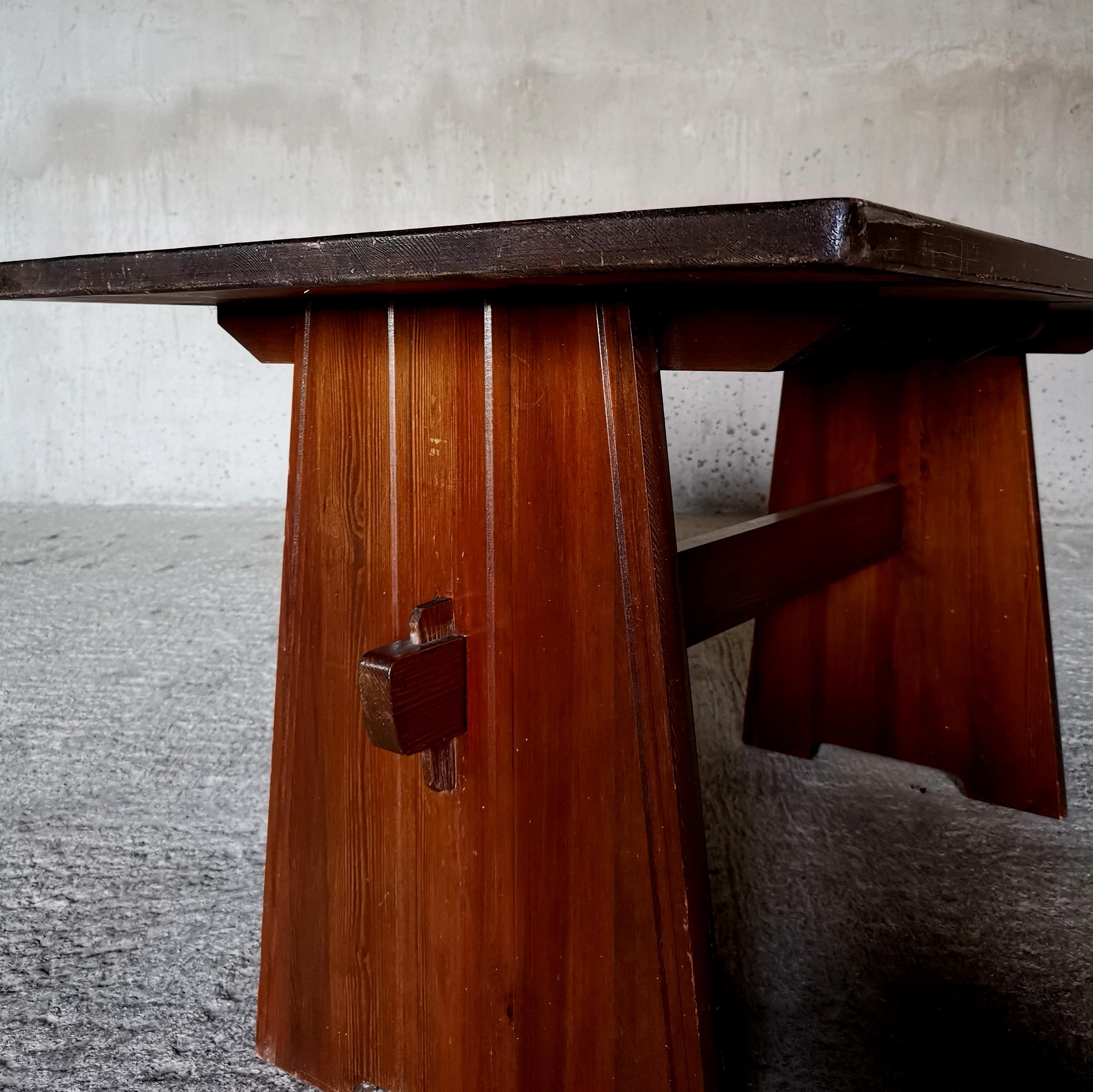 Dining table in solid pine, in the style of Axel Einar Hjorth and Göran Malmvall
Sweden 1940s.
Good vintage condition and beautiful dark brown patina. 

W: 130 cm D: 76 cm H: 72 cm 
Table top thickness: 3 cm