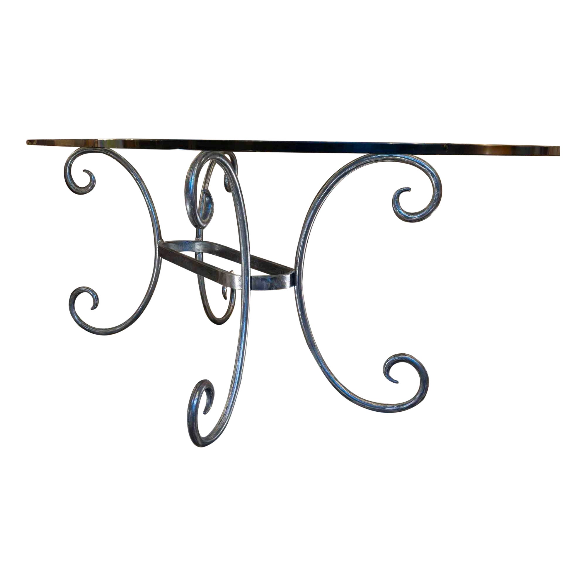 Dining table in solid wrought iron and glass top, 20th century.