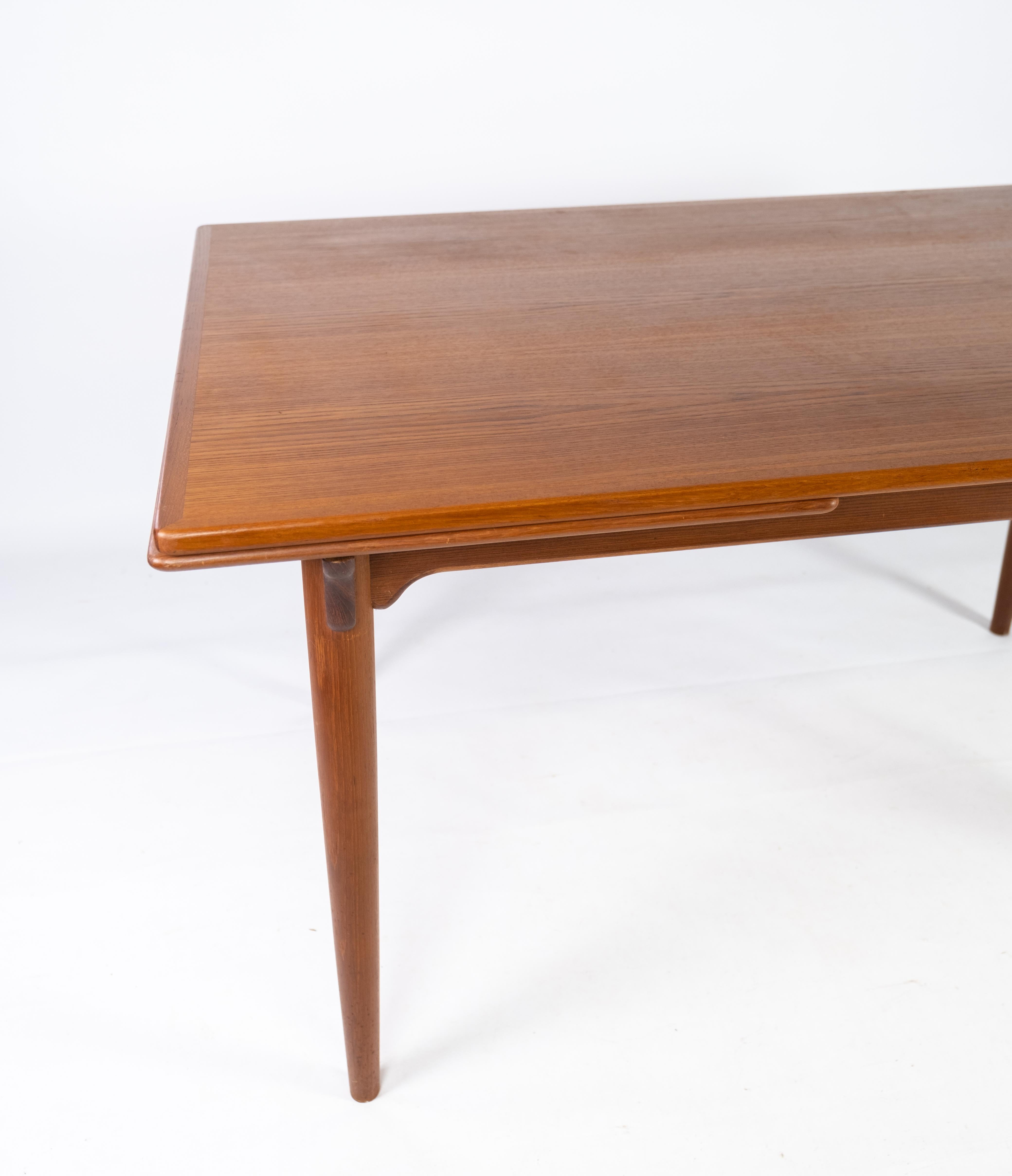 This teak dining table embodies the essence of Danish design from the 1960s, characterized by its sleek lines, functional versatility, and impeccable craftsmanship. Crafted from teak, a favored material for Danish furniture makers of the era, this