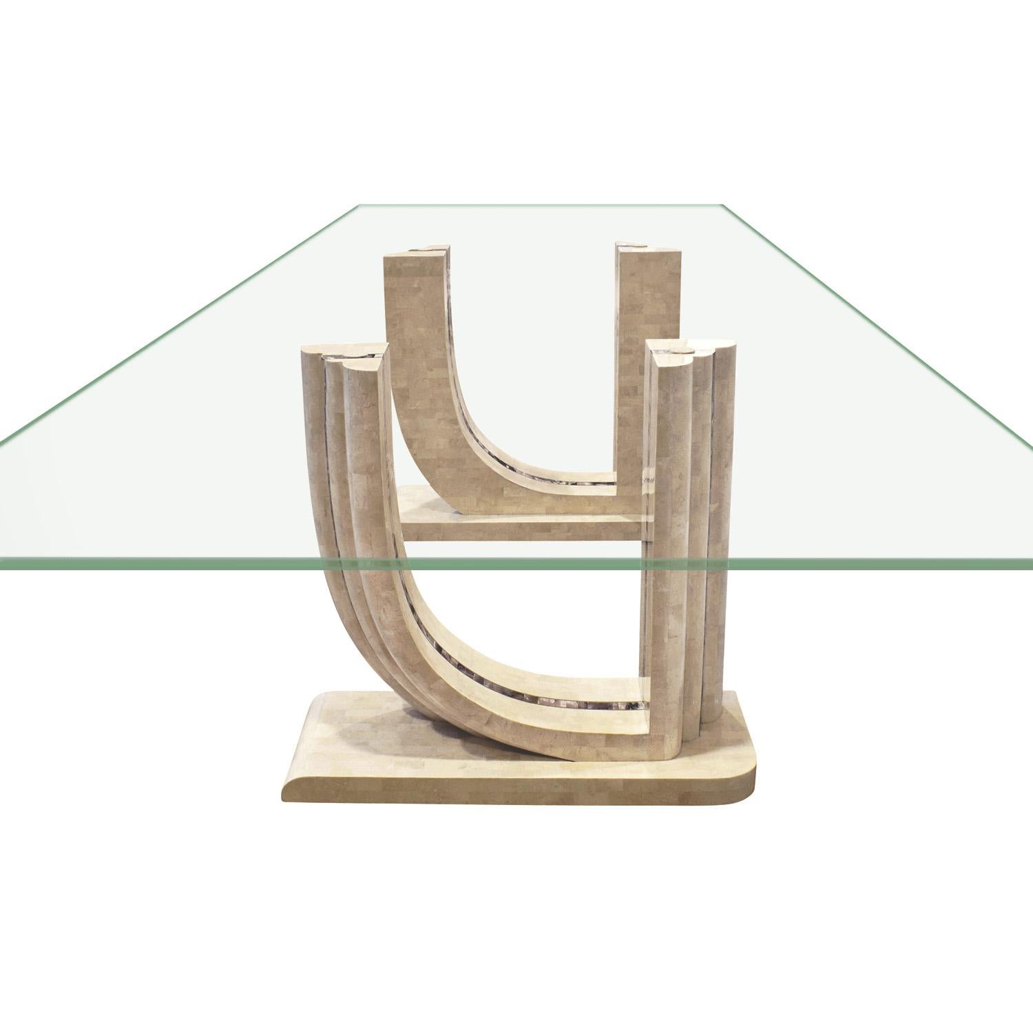 Dining table with 2 bases in tessellated fossilized coral with abalone and brass inlays with glass top by Maitland Smith, American 1970's. Each base measures 31 inches x 12 inches x 28.5 inches high.
The combination of exotic materials is very chic