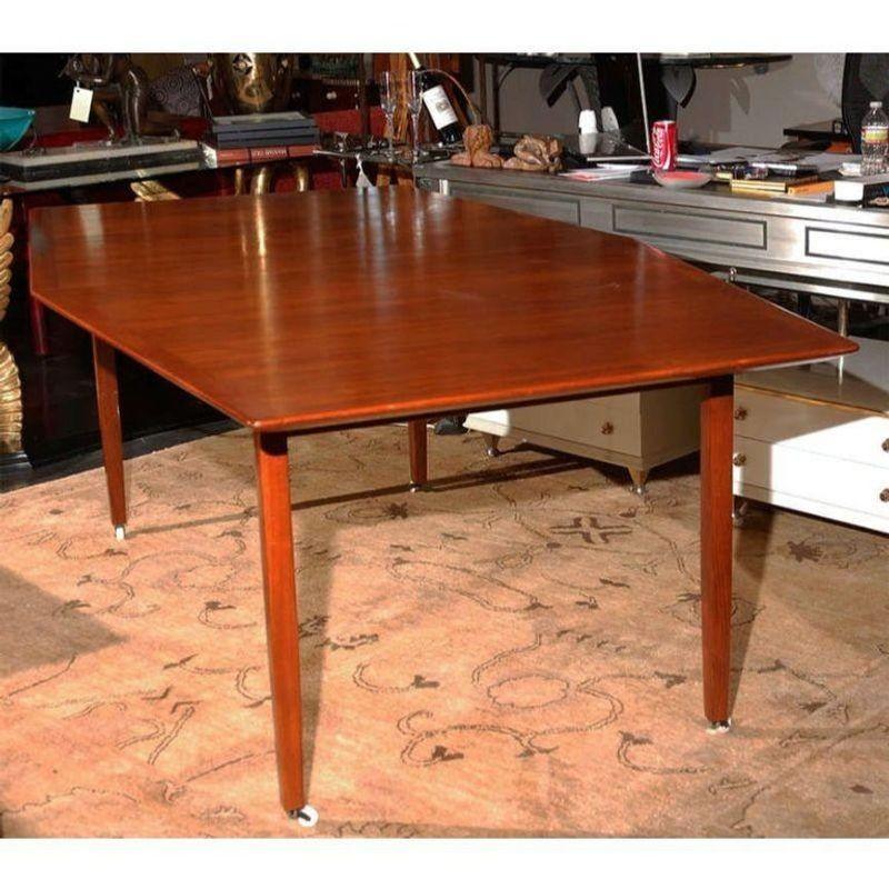 Dining table In the Style of Hans Wegner. Has original white porcelain casters. Very comfortably seats six.